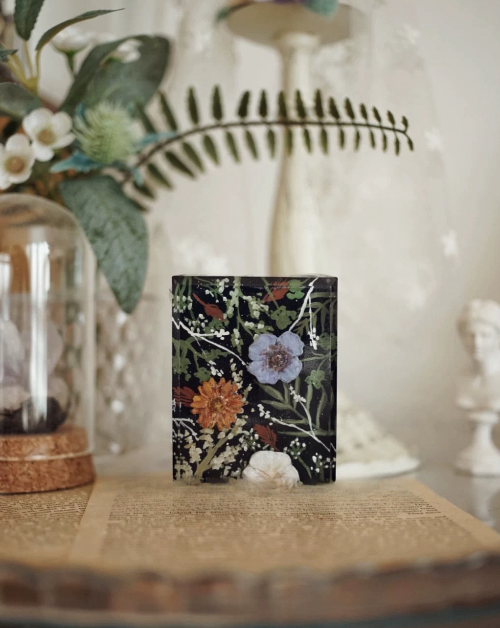 A beautifully arranged set of Botanical Garden Bliss Handmade Soaps, showcasing unique colors and textures, surrounded by natural elements.