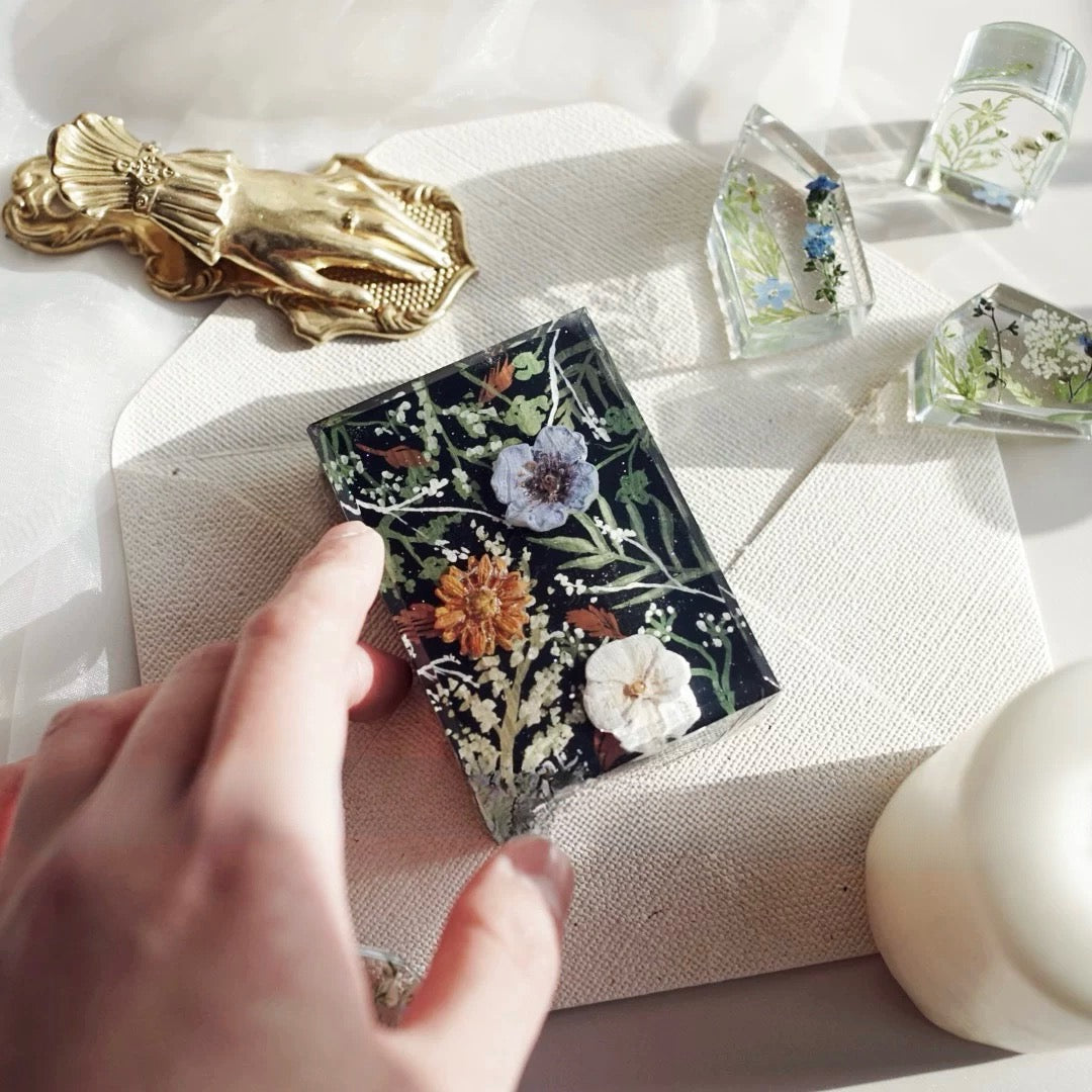 A beautifully arranged set of Botanical Garden Bliss Handmade Soaps, showcasing unique colors and textures, surrounded by natural elements.