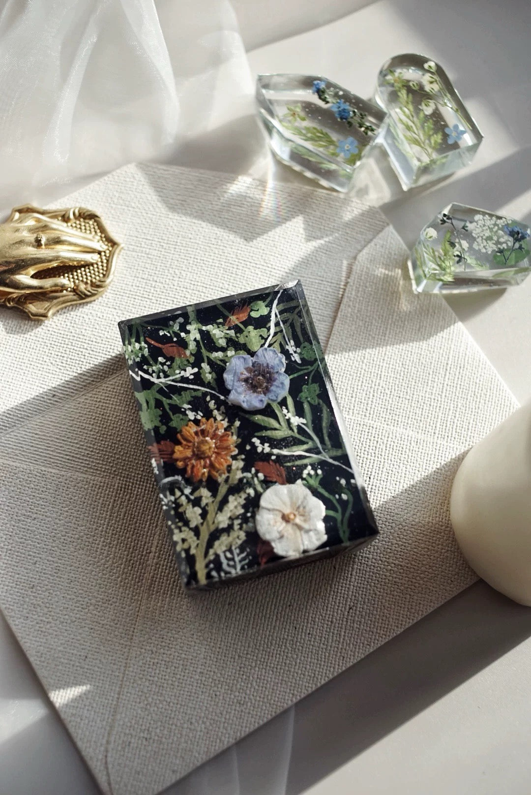 A beautifully arranged set of Botanical Garden Bliss Handmade Soaps, showcasing unique colors and textures, surrounded by natural elements.