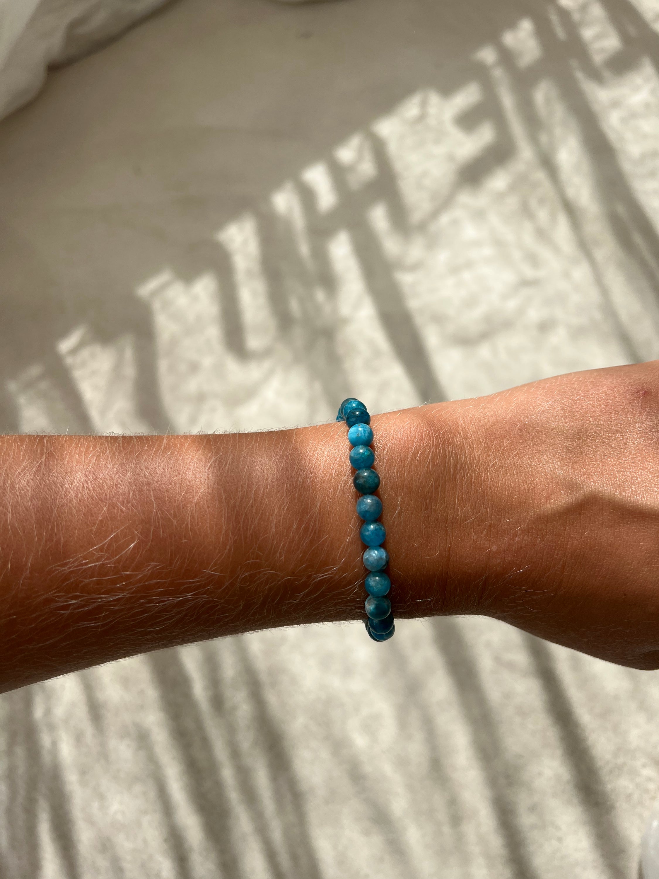 A delicate baby bracelet made of blue apatite beads, symbolizing creativity and inspiration, perfect for enhancing energy.