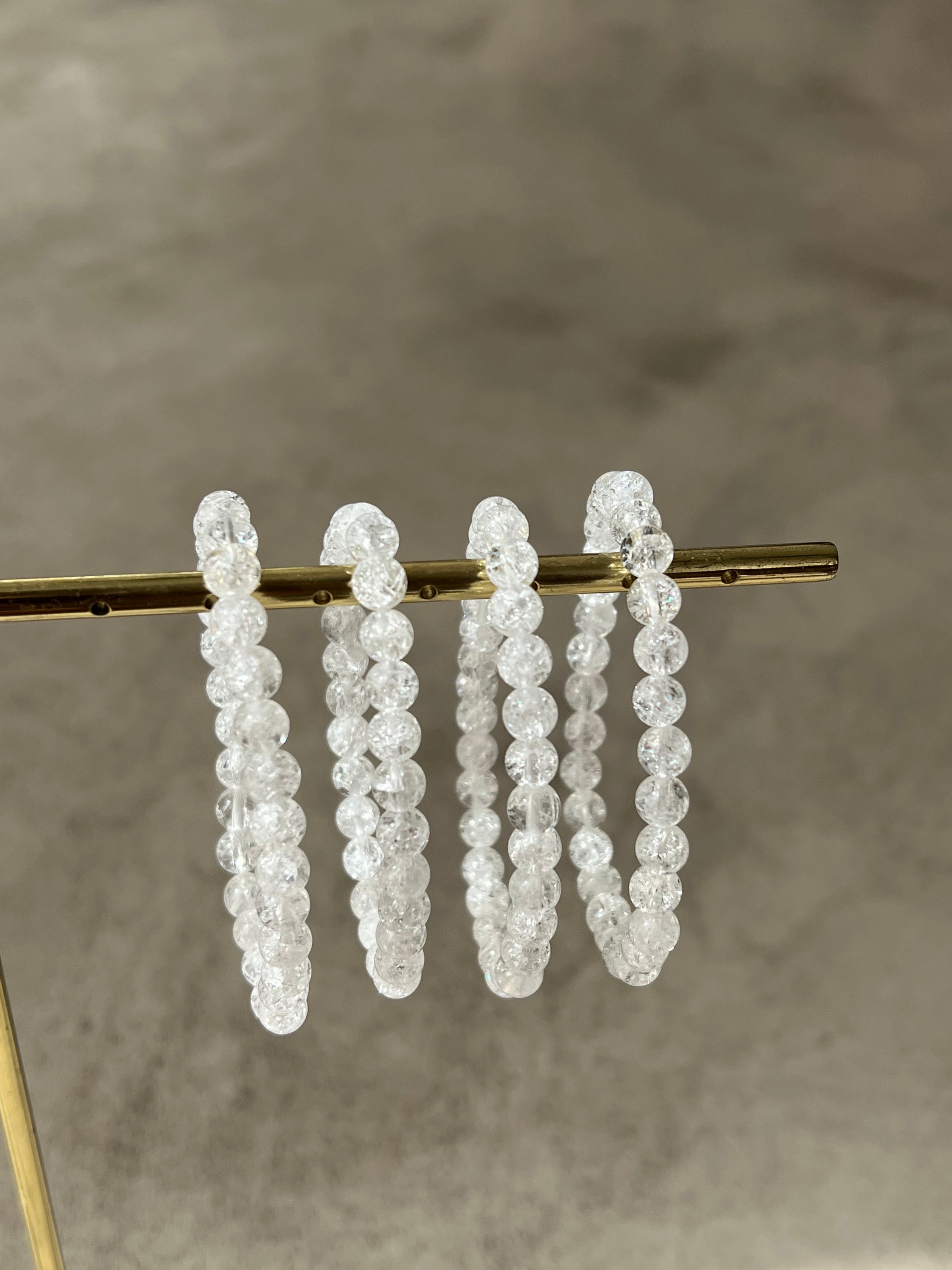 A stylish bracelet made of crystal de roche beads, symbolizing intuition and energy enhancement.