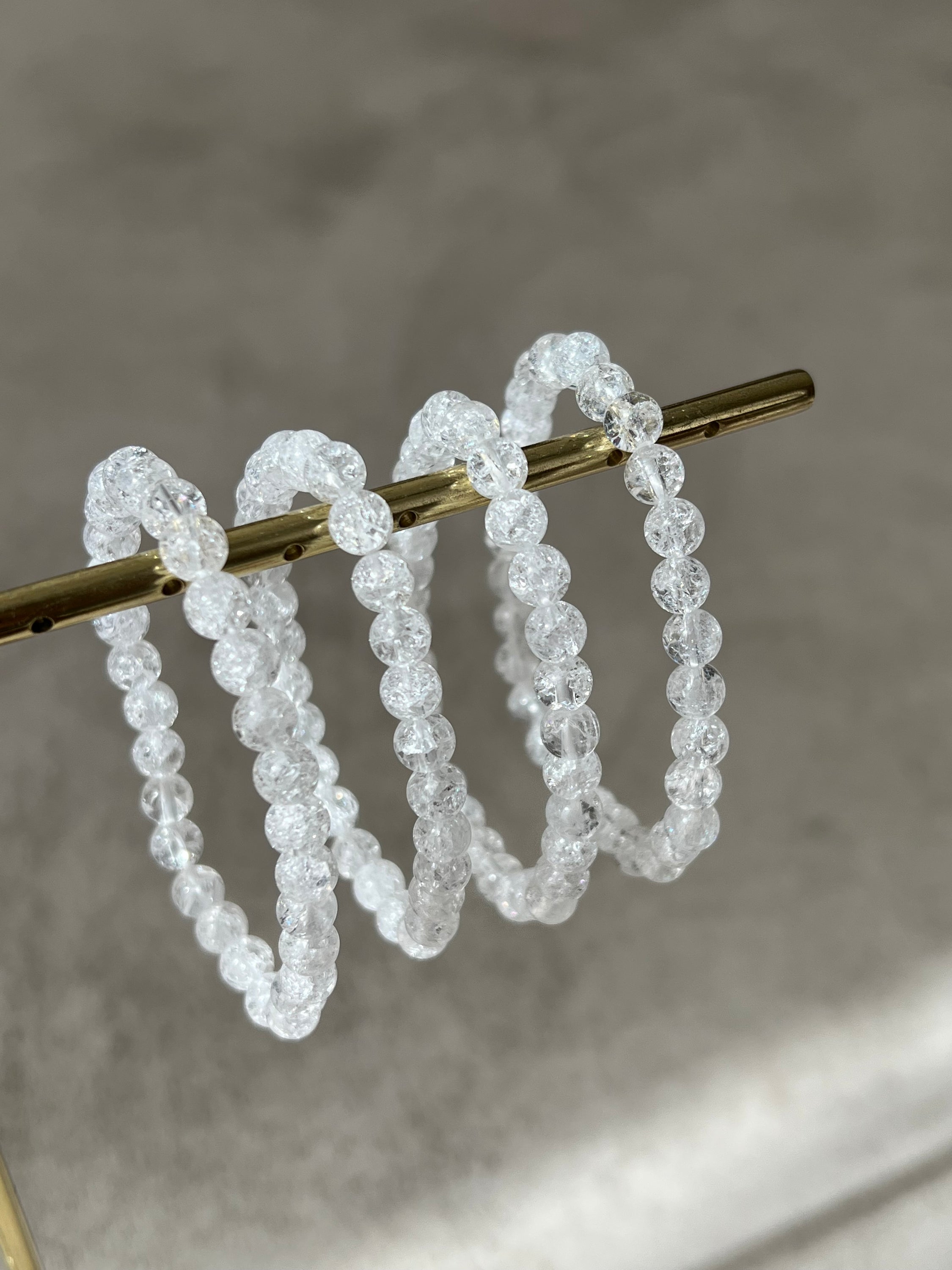 A stylish bracelet made of crystal de roche beads, symbolizing intuition and energy enhancement.