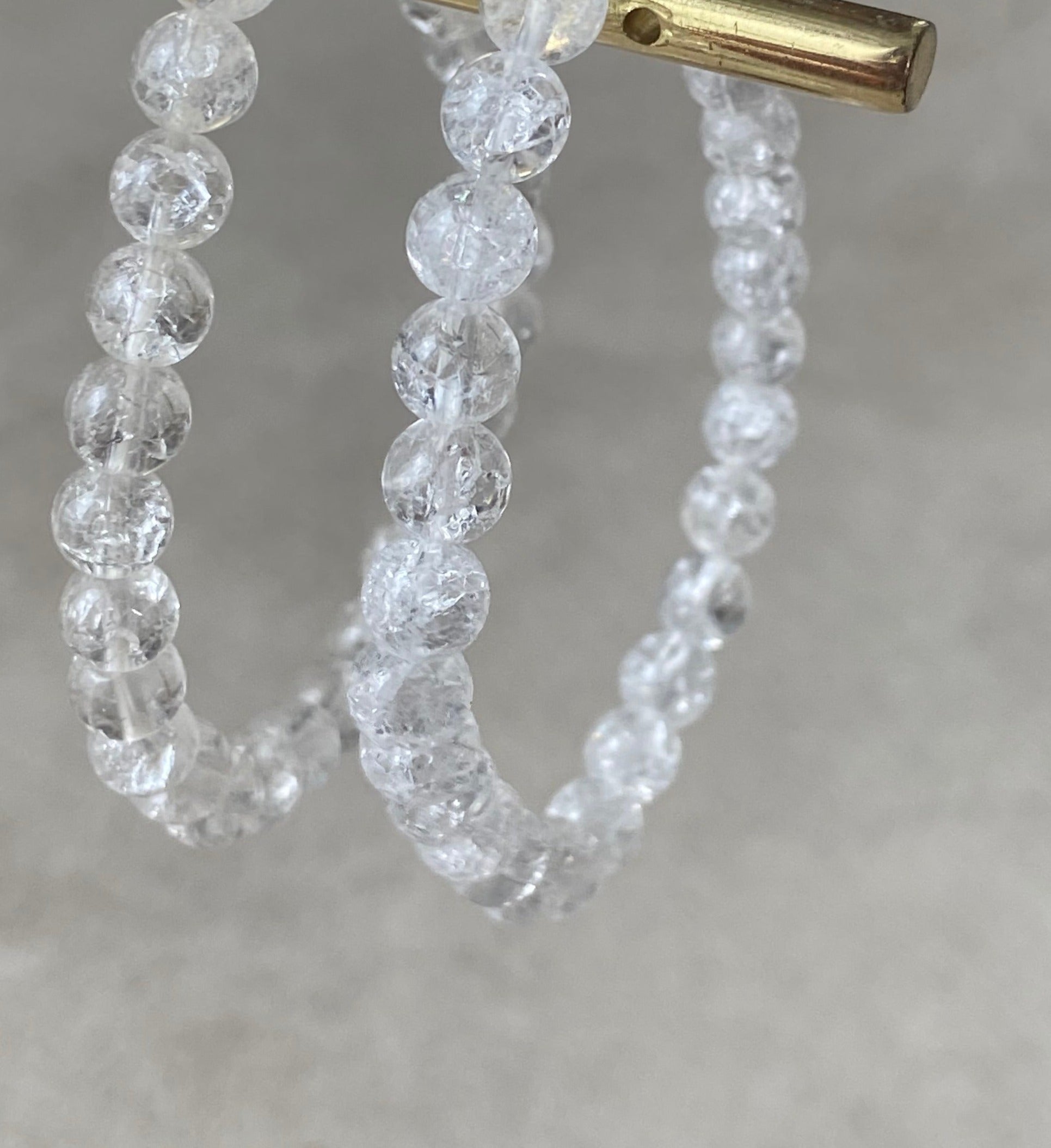 A stylish bracelet made of crystal de roche beads, symbolizing intuition and energy enhancement.