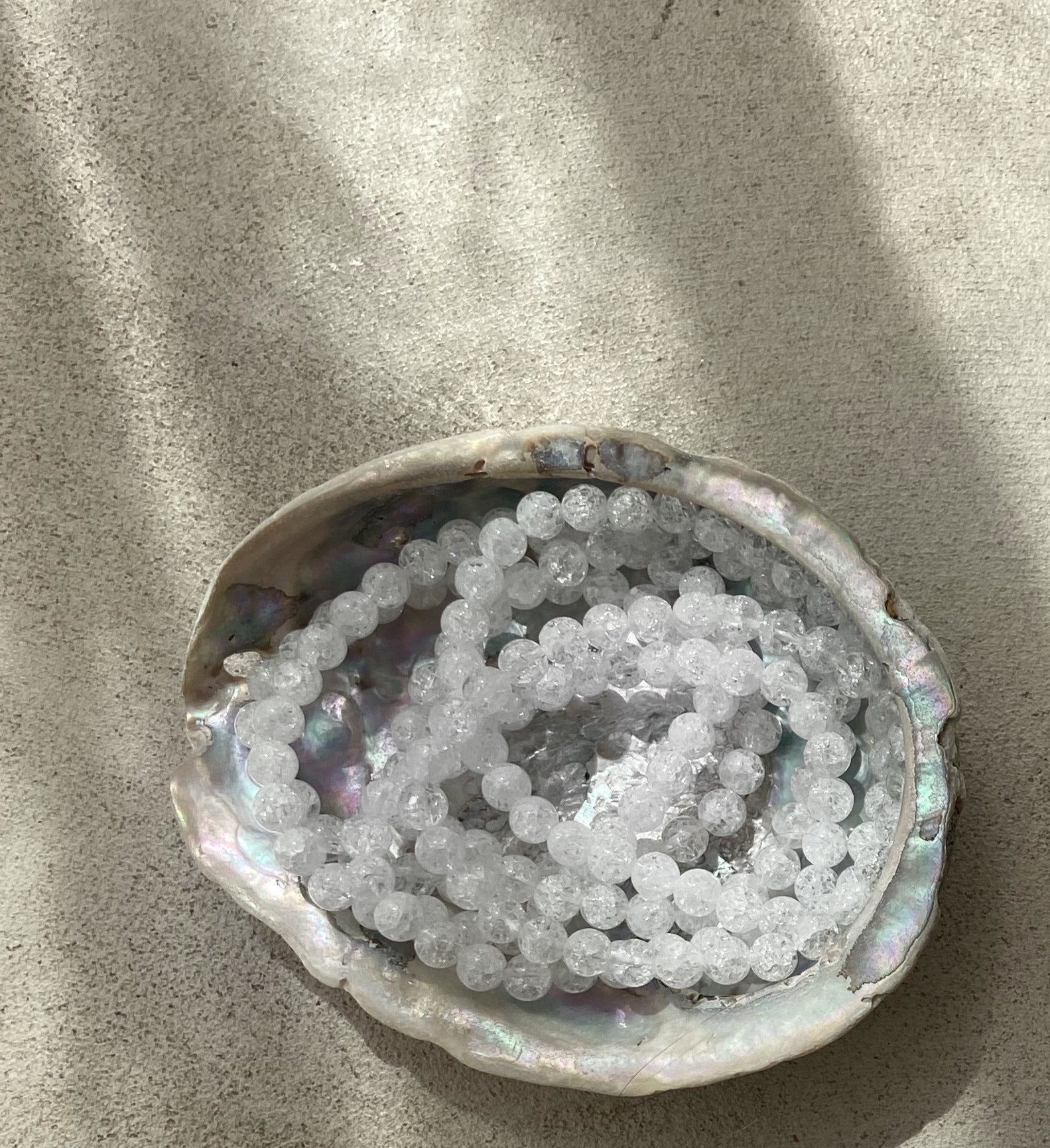 A stylish bracelet made of crystal de roche beads, symbolizing intuition and energy enhancement.