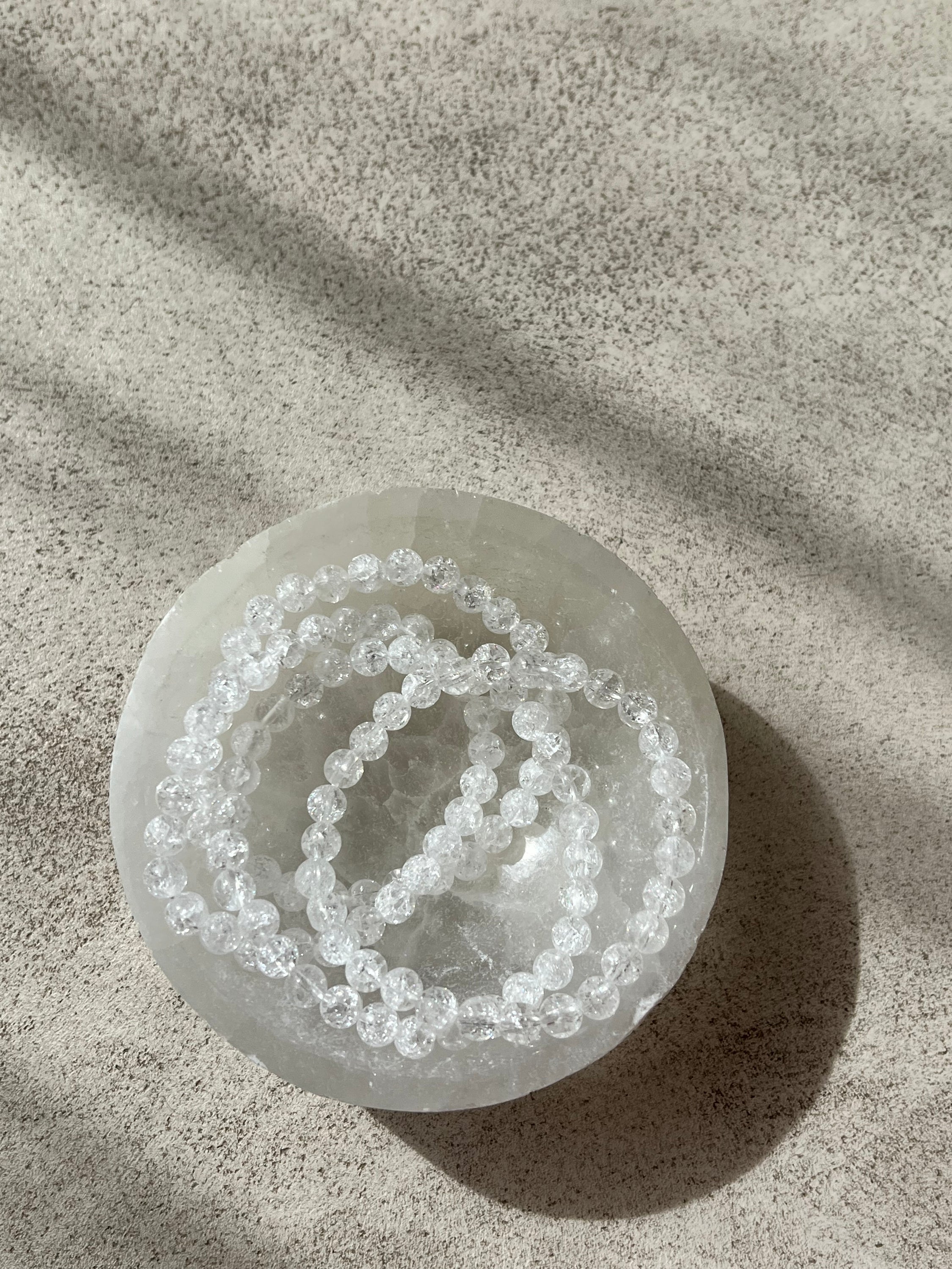 A stylish bracelet made of crystal de roche beads, symbolizing intuition and energy enhancement.