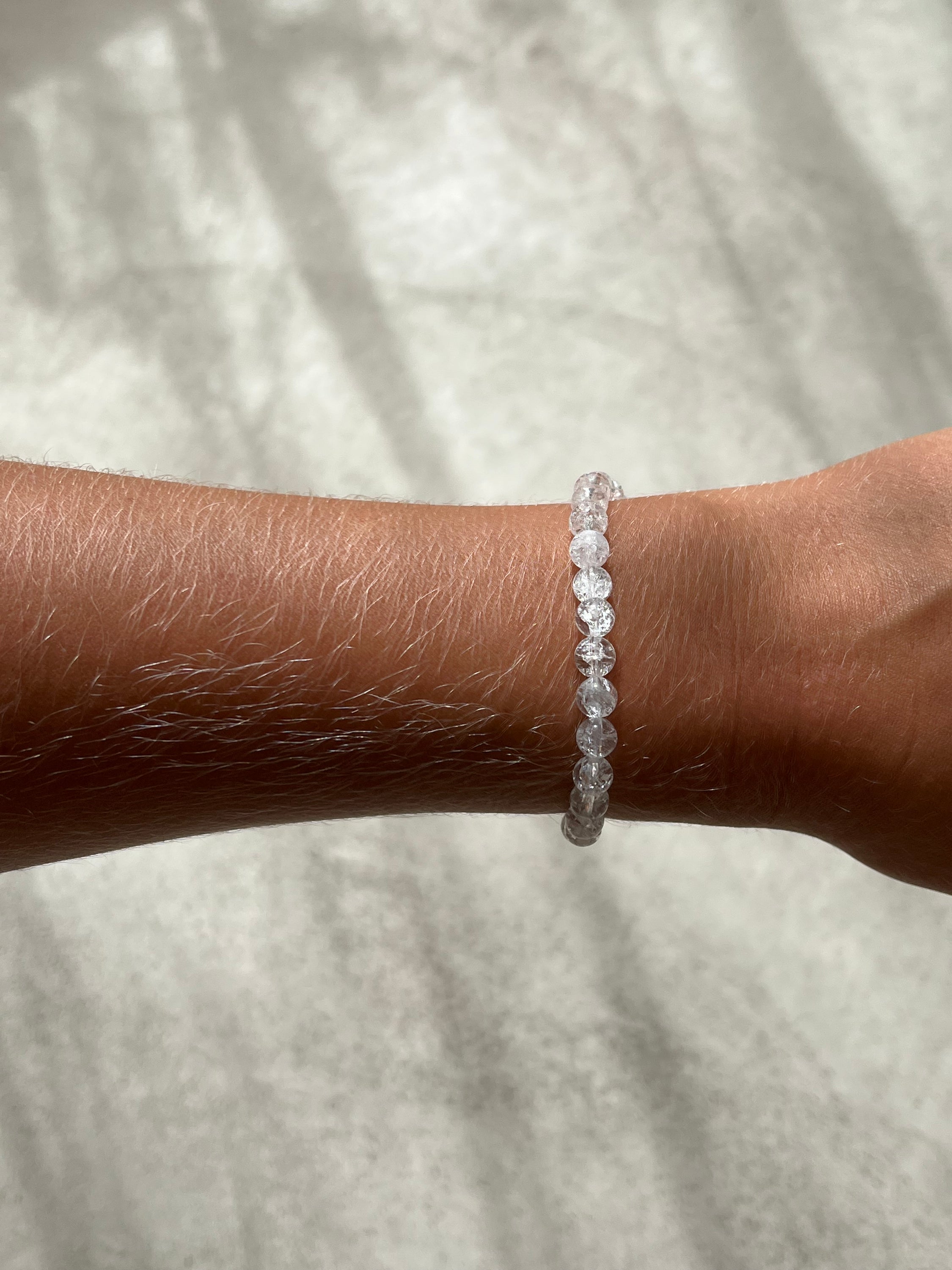 A stylish bracelet made of crystal de roche beads, symbolizing intuition and energy enhancement.