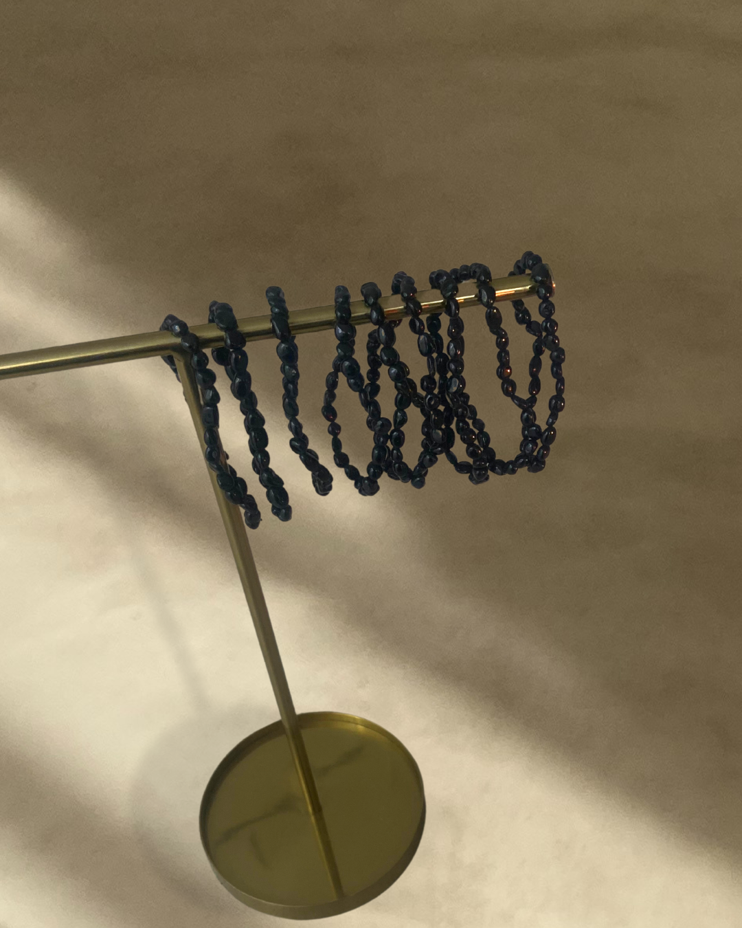 A stylish bracelet made of black tourmaline stones, symbolizing protection and energy balance.