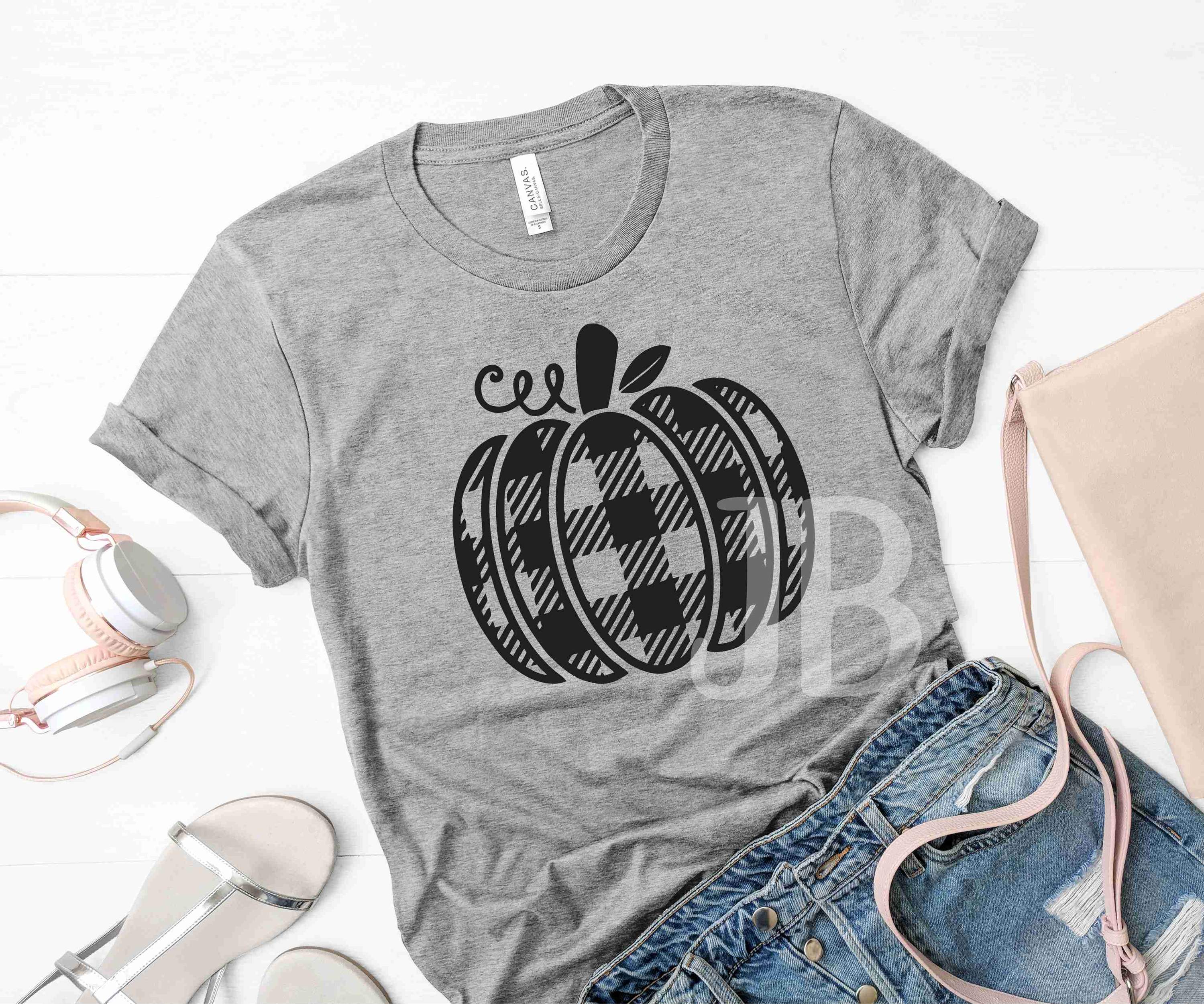 Buffalo Plaid Pumpkin Graphic T-Shirt displayed on a hanger, featuring a vibrant pumpkin design in plaid pattern.