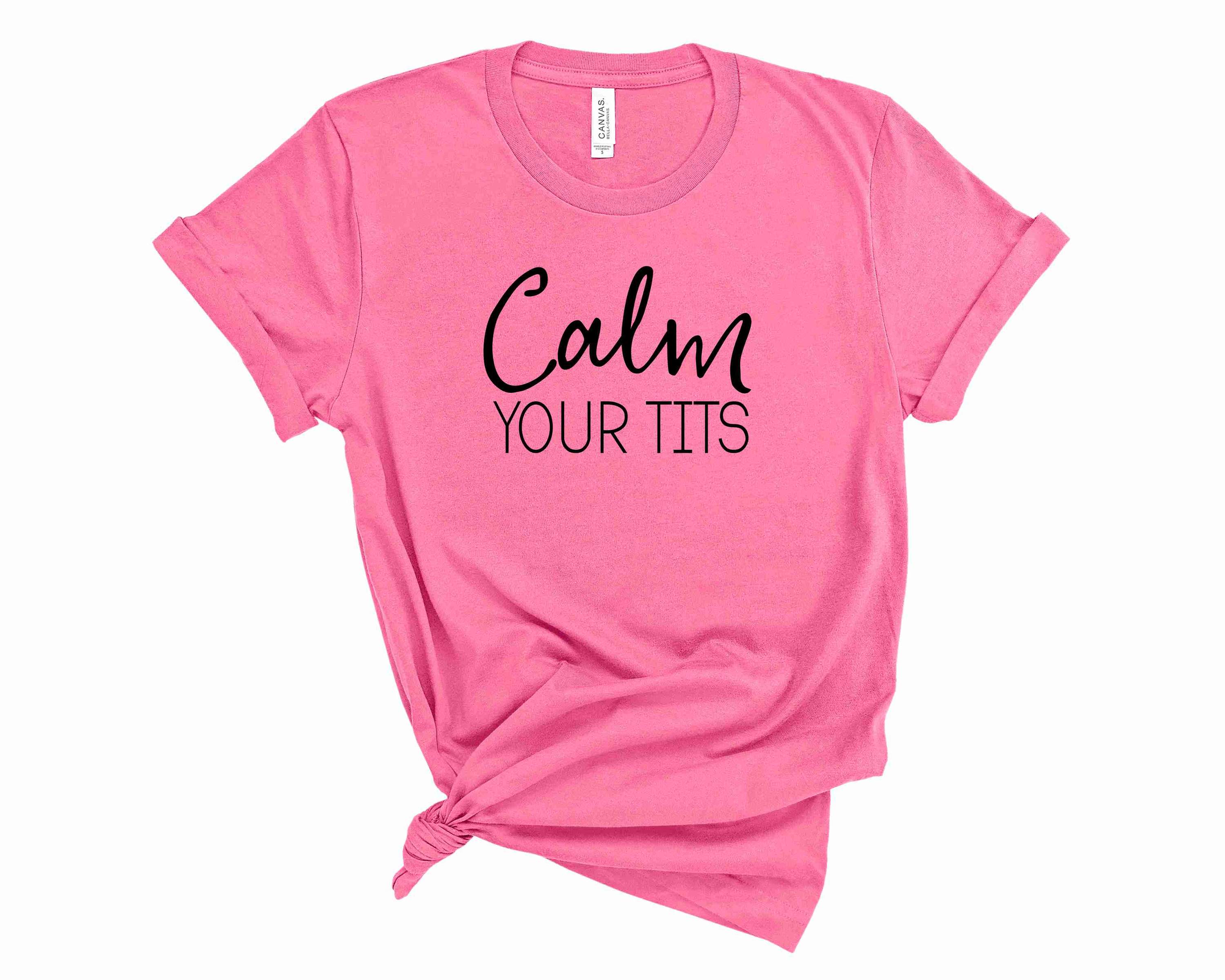 A stylish unisex graphic tee featuring the phrase 'Calm Your Tits' in bold letters, perfect for casual wear.