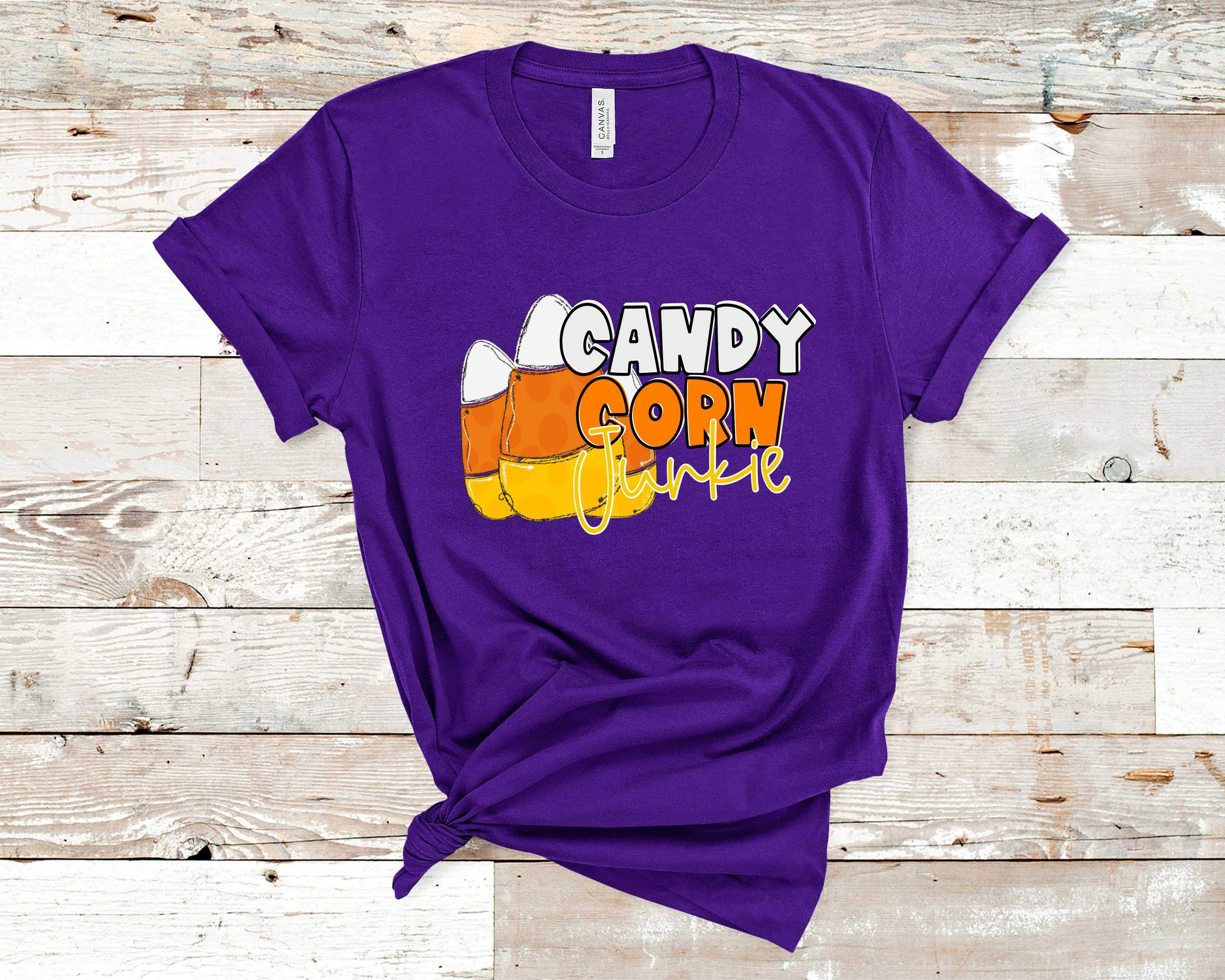 Candy Corn Junkie graphic tee featuring a vibrant candy corn design on a soft Bella Canvas fabric.