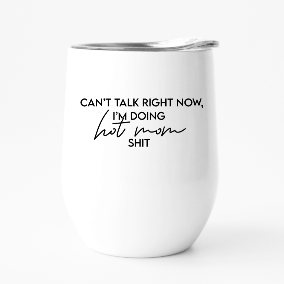 A stylish 12oz travel tumbler with the phrase 'CAN'T TALK RIGHT NOW, I'M DOING HOT MOM SHIT' printed on it, perfect for hot moms on the go.