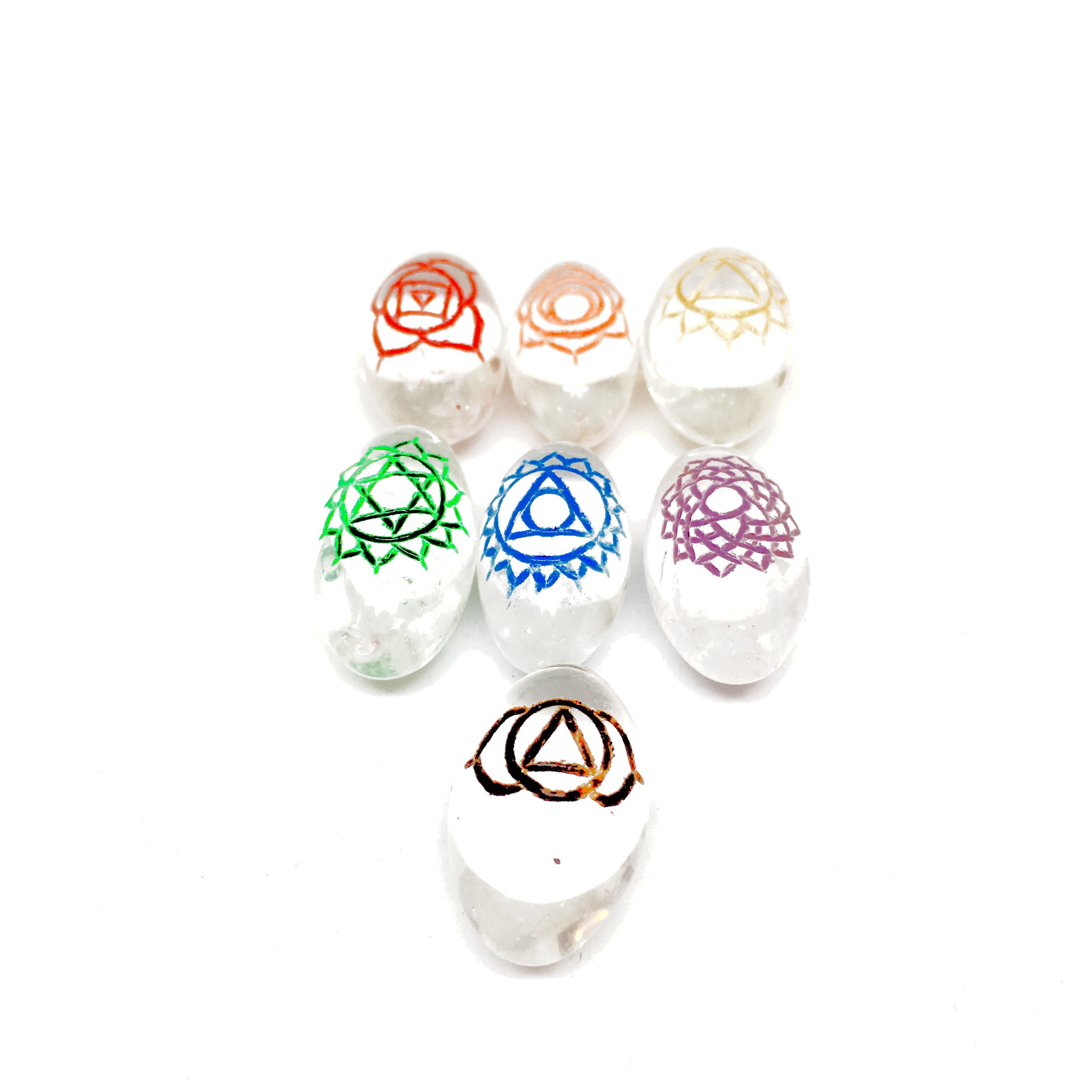 Colorful chakra stones arranged in rows.