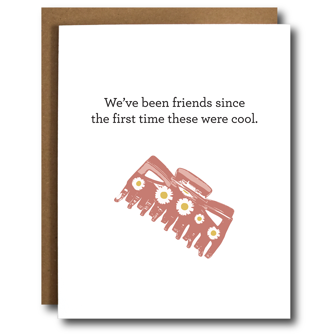 A colorful greeting card featuring a humorous design related to claw clips, perfect for celebrating nostalgia and friendship.