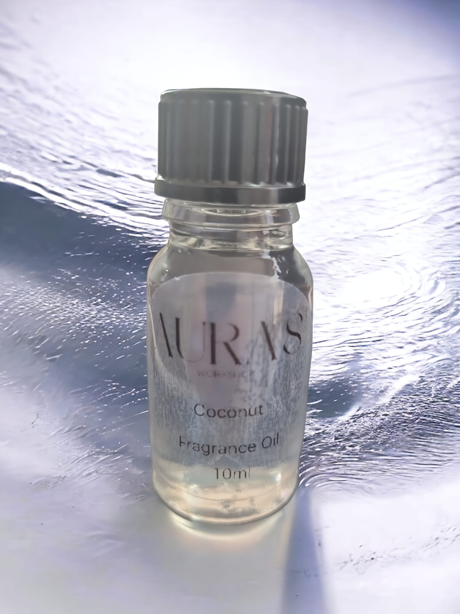 10ml bottle of Coconut Fragrance Oil with a tropical coconut design, showcasing its sweet aroma.