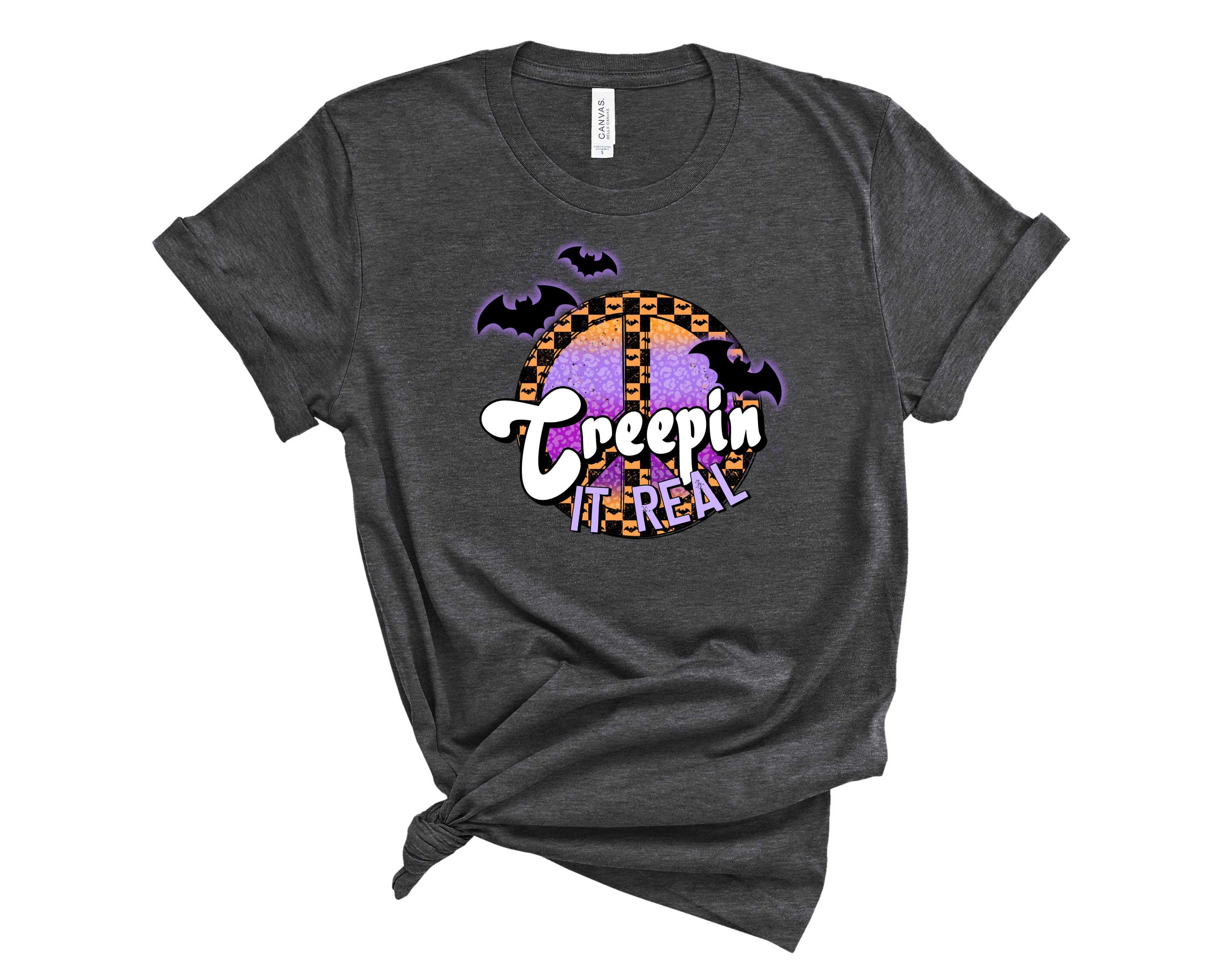 A stylish unisex graphic tee featuring the phrase 'Creep it Real' in bold letters, perfect for Halloween.