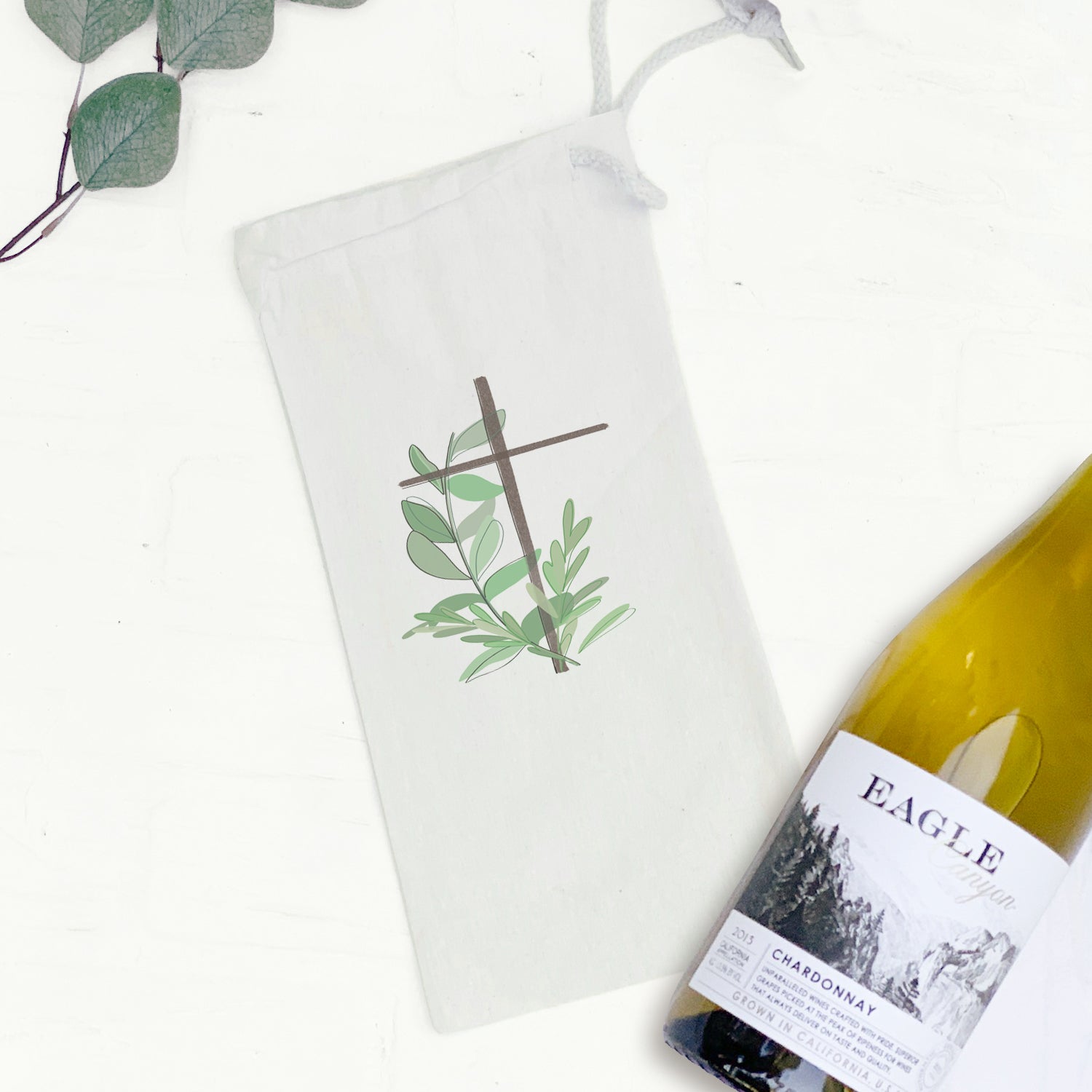 Cross with Leaves Canvas Wine Bag featuring a stylish design and drawstring closure, perfect for gifting wine.