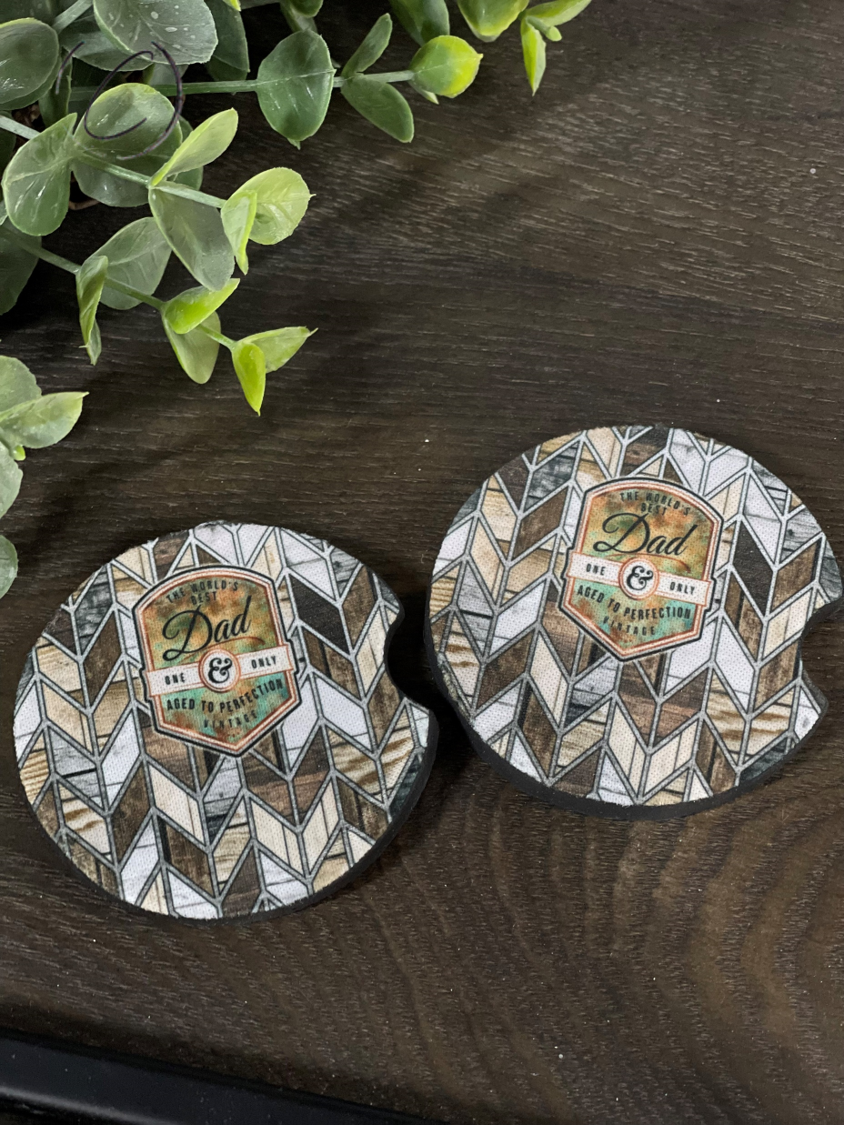 A stylish Dad, Aged To Perfection car coaster set made of durable neoprene, featuring a unique design.