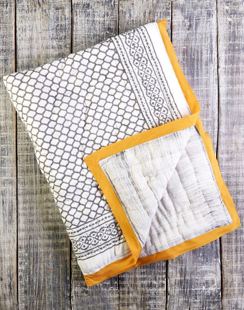 ERAWAN Cotton Quilt featuring soft cotton voile exterior, unique hand-stitched designs, and reversible patterns, handcrafted in India.