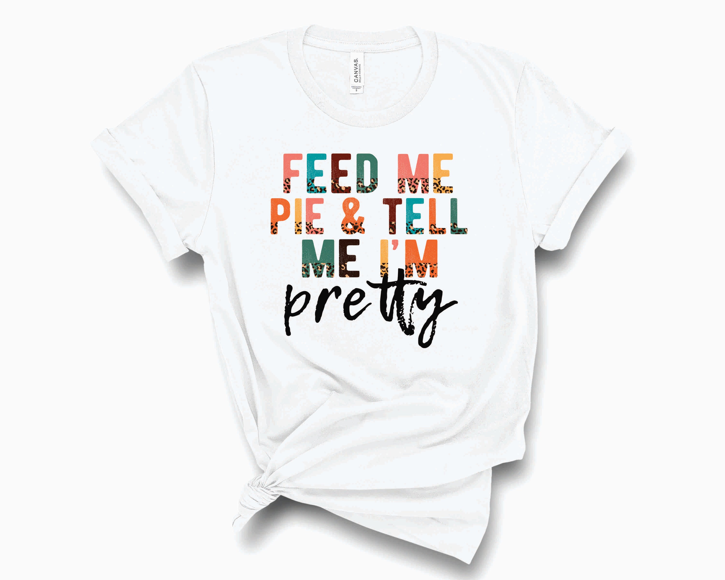 A stylish unisex graphic tee featuring a half leopard design with the text 'Feed Me & Tell Me I'm Pretty' in a playful font.