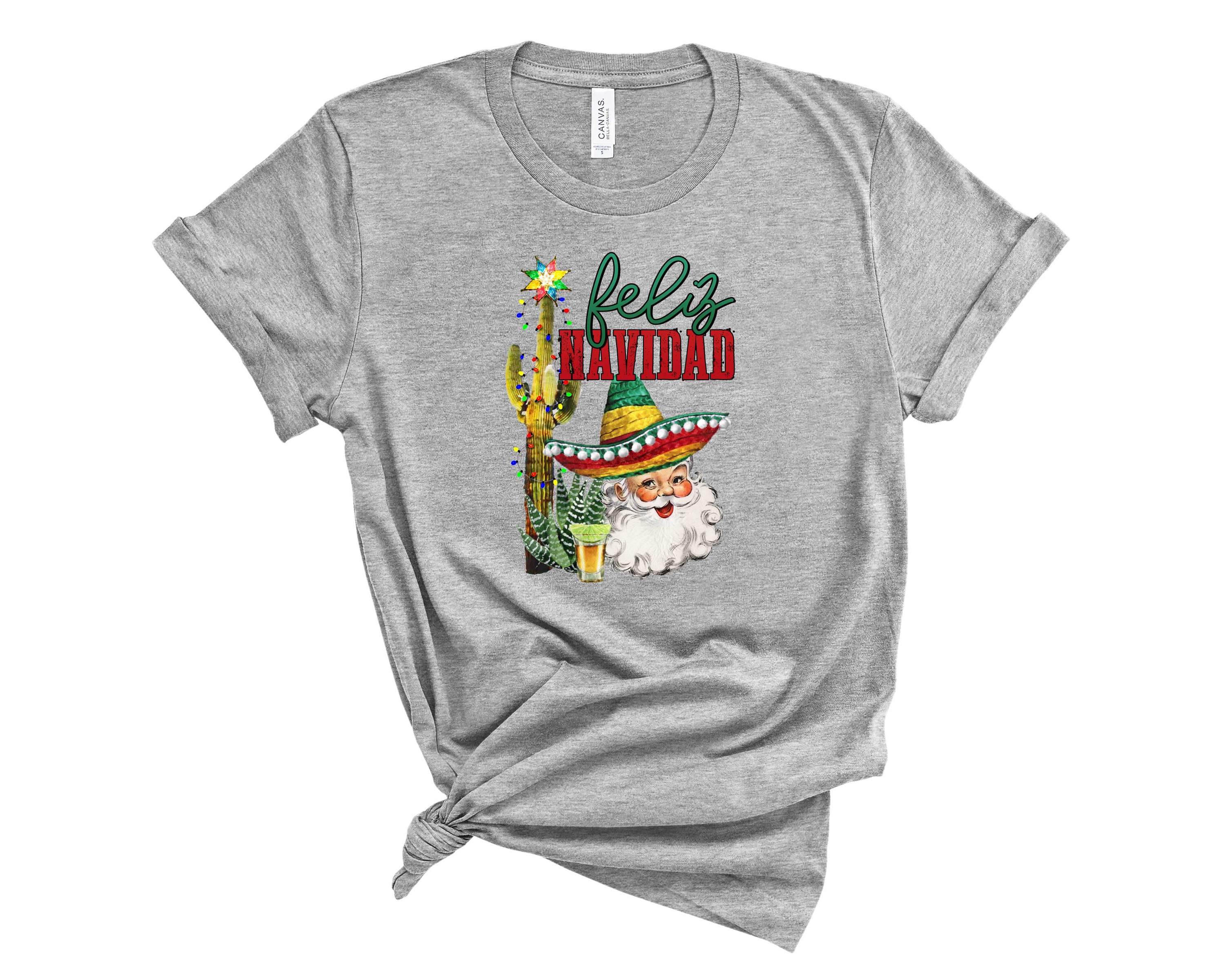Feliz Navidad graphic tee featuring festive holiday design, unisex fit, and soft fabric, perfect for Christmas celebrations.