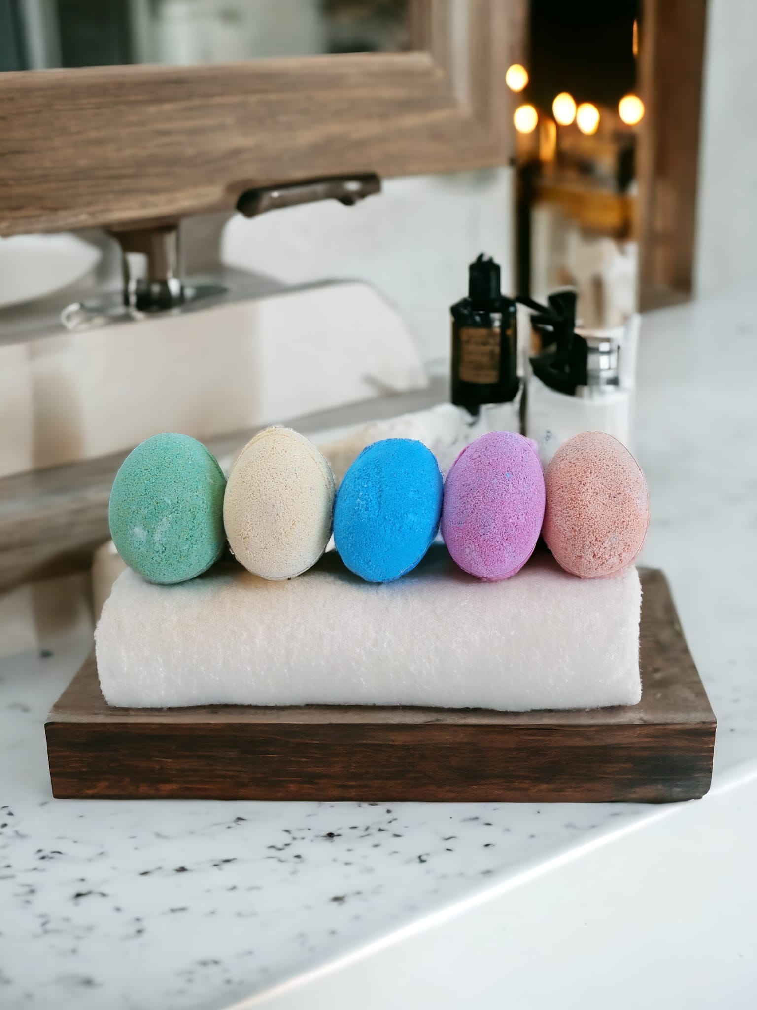 A colorful assortment of six Fizzy Egg Bath Bombs in purple, blue, yellow, green, and orange, beautifully arranged in a Kraft bag with an open window.