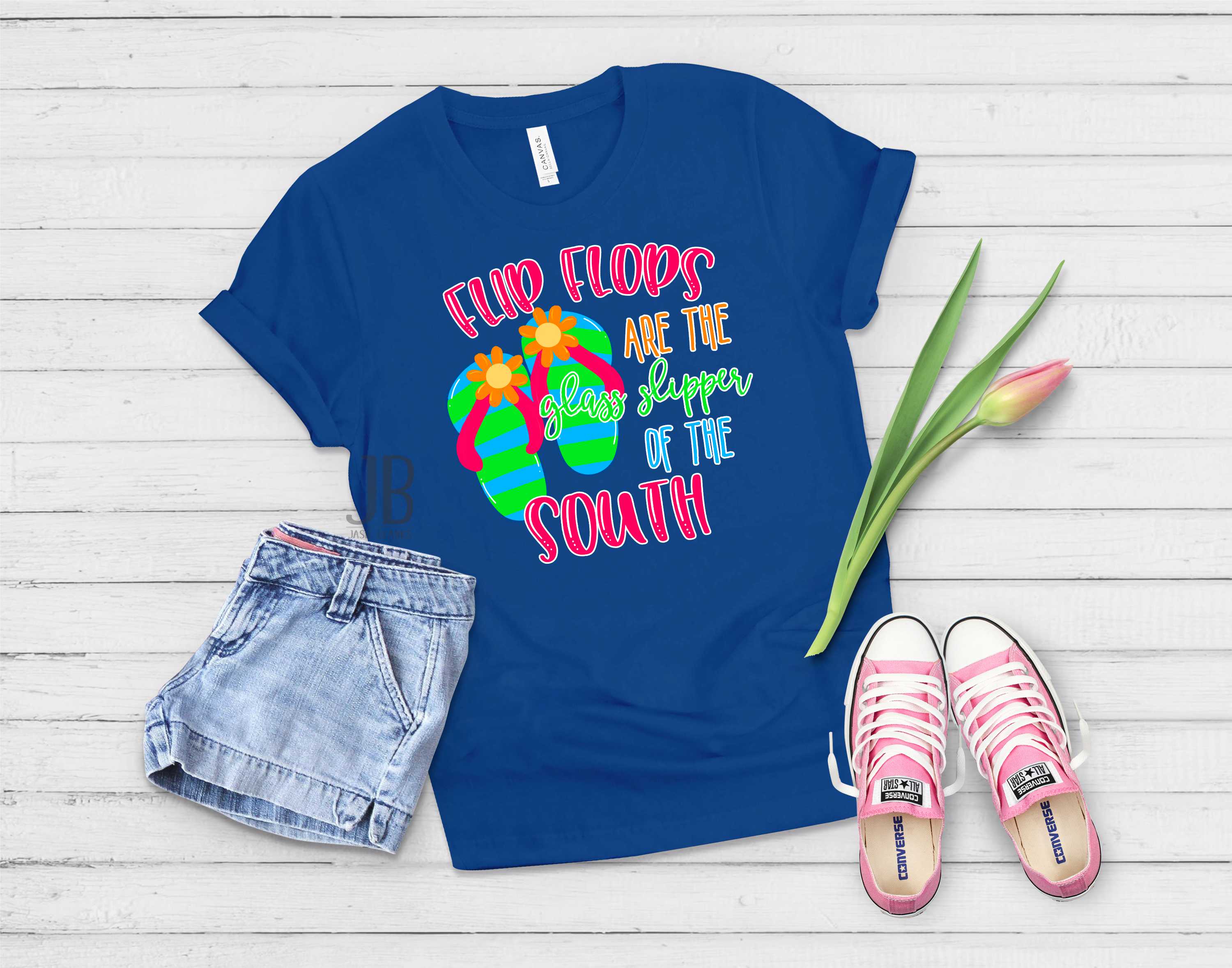 A unisex graphic tee featuring the phrase 'Flip Flops are the Glass Slippers of the South' in vibrant colors, perfect for summer wear.