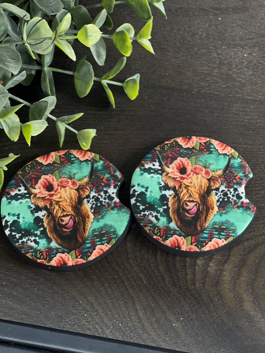 Floral Highland Cow car coaster set featuring a vibrant floral design on durable neoprene material, perfect for car cup holders.