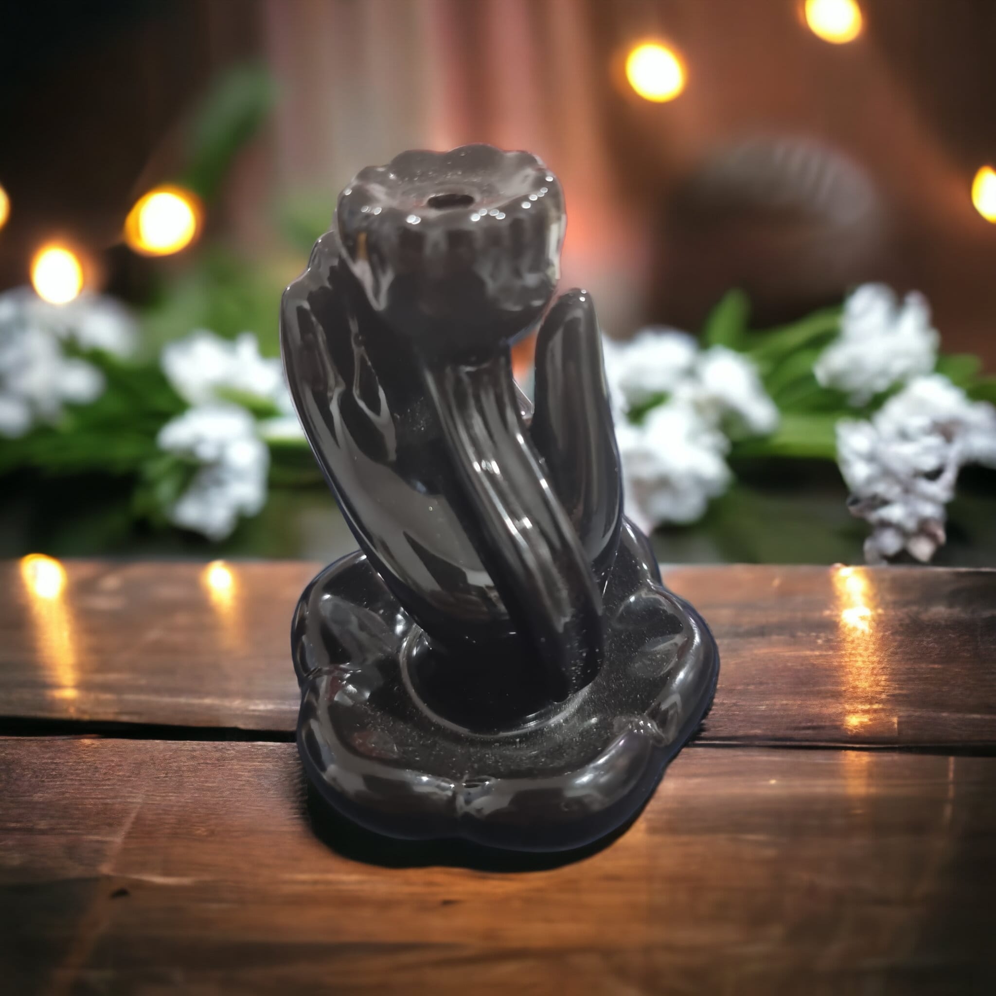 A beautifully crafted Flower Hand Backflow Incense Burner, featuring a hand holding a flower with cascading smoke for a serene ambiance.