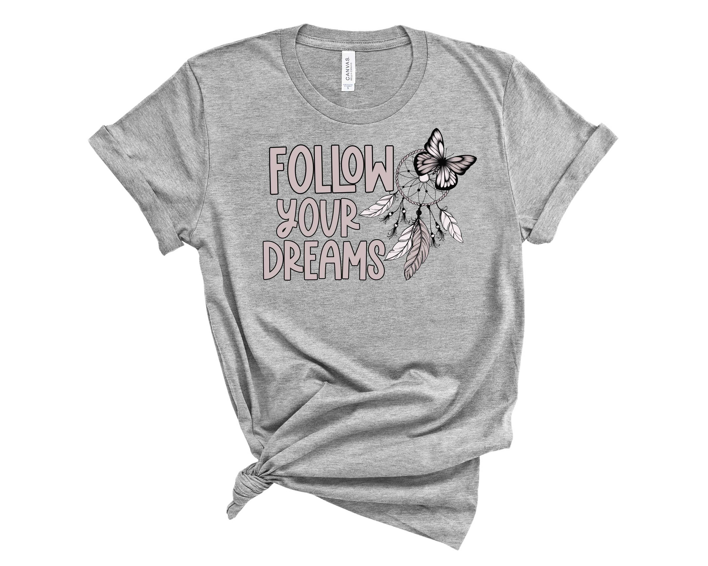 A unisex Follow Your Dreams Graphic Tee featuring an inspirational print on a soft fabric.