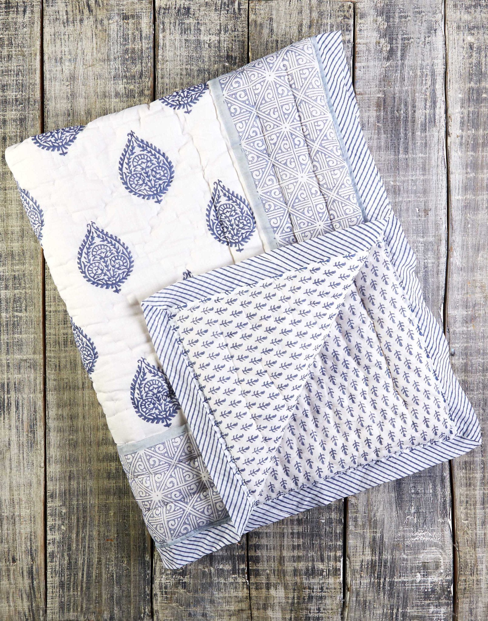 FORT Cotton Quilt featuring soft cotton voile exterior and unique hand-stitched designs, showcasing its reversible pattern.