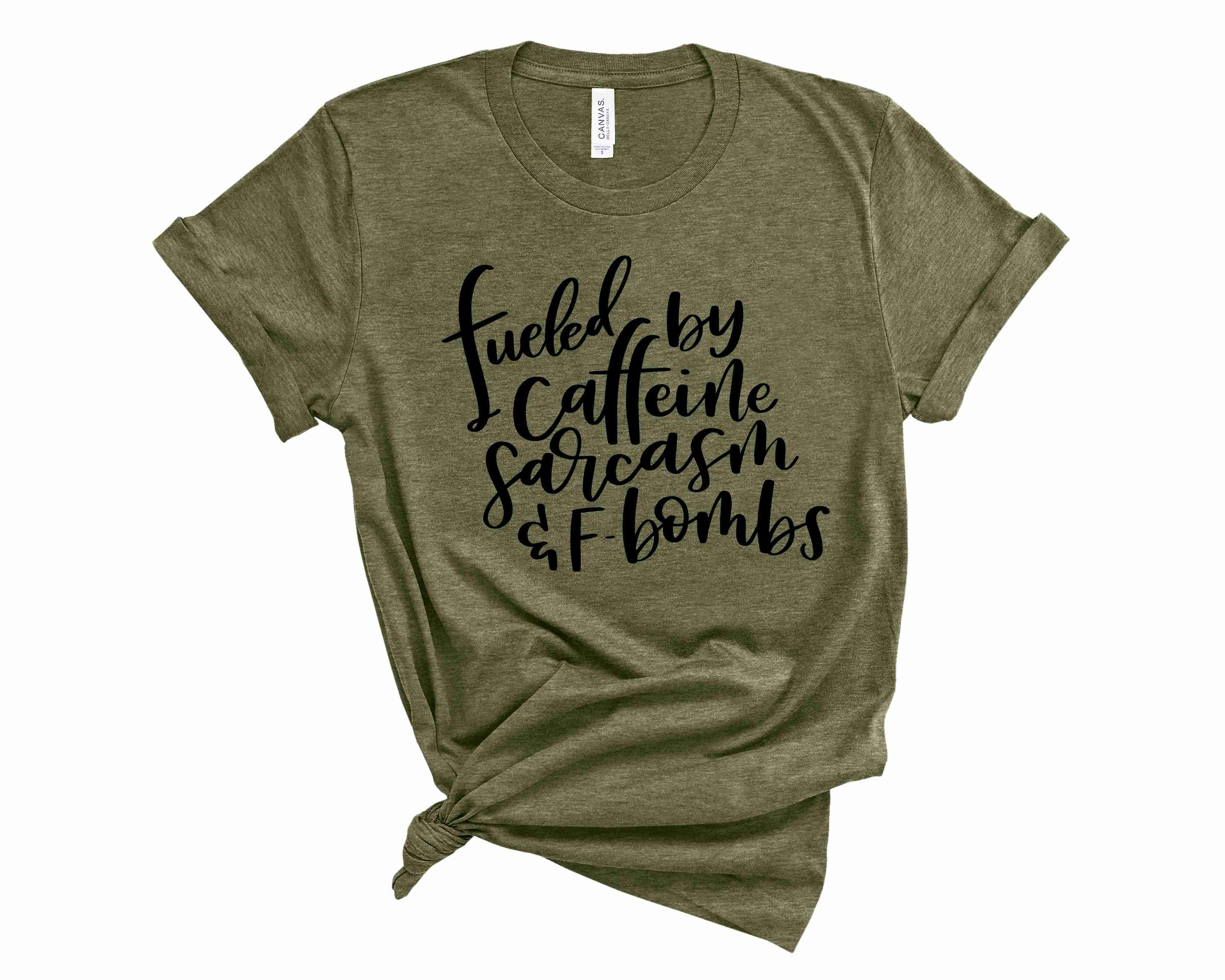 A stylish unisex graphic tee featuring the words 'Fueled By' in bold print, perfect for casual wear.