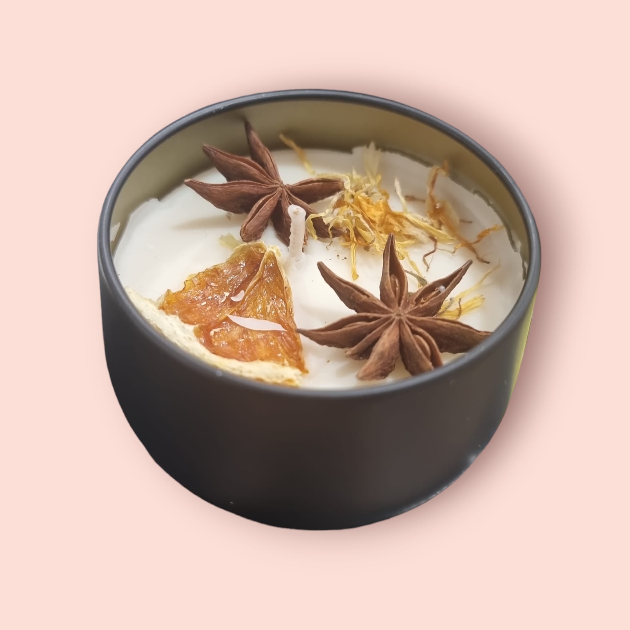 Golden Hour Winter Candle Tin with a warm glow, showcasing its stylish design and inviting fragrance.