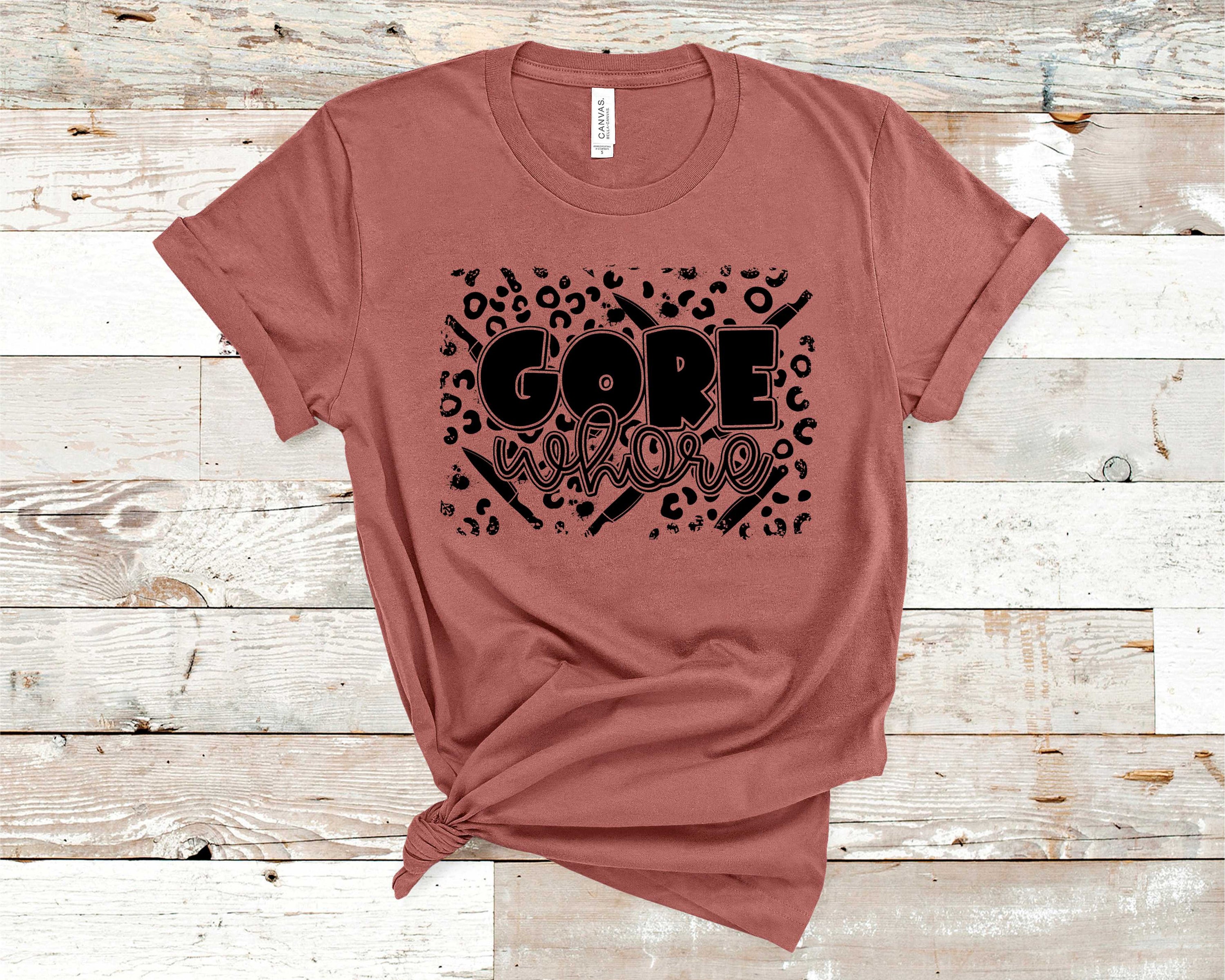 Gore Whore Graphic Tee featuring bold design on a soft fabric, suitable for unisex wear.