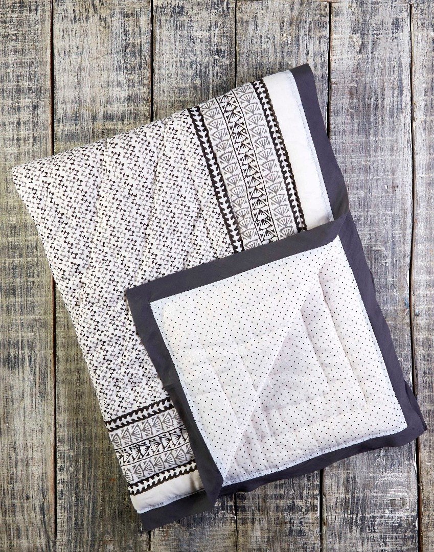 A beautifully handcrafted GREENWICH COTTON QUILT featuring unique block-printed designs and a luxurious soft texture.