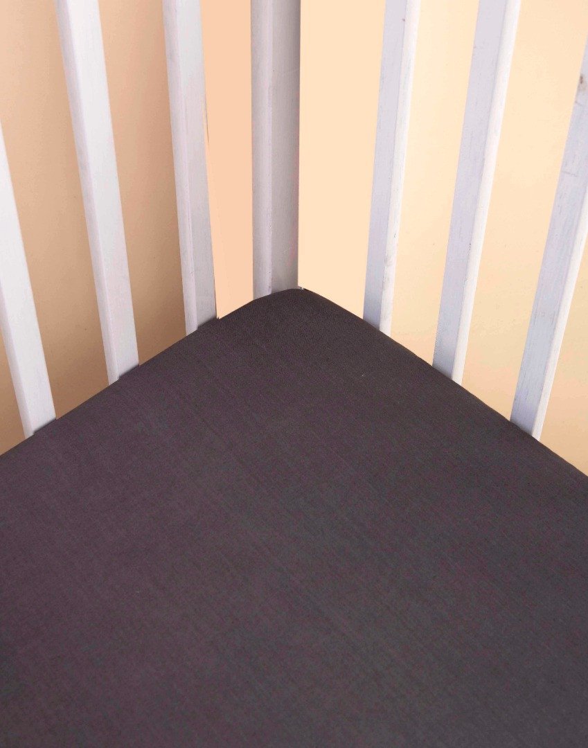 Greenwich Fitted Crib Sheet made of ultra-soft cotton voile, featuring concealed elastic for a snug fit and unique handcrafted design.