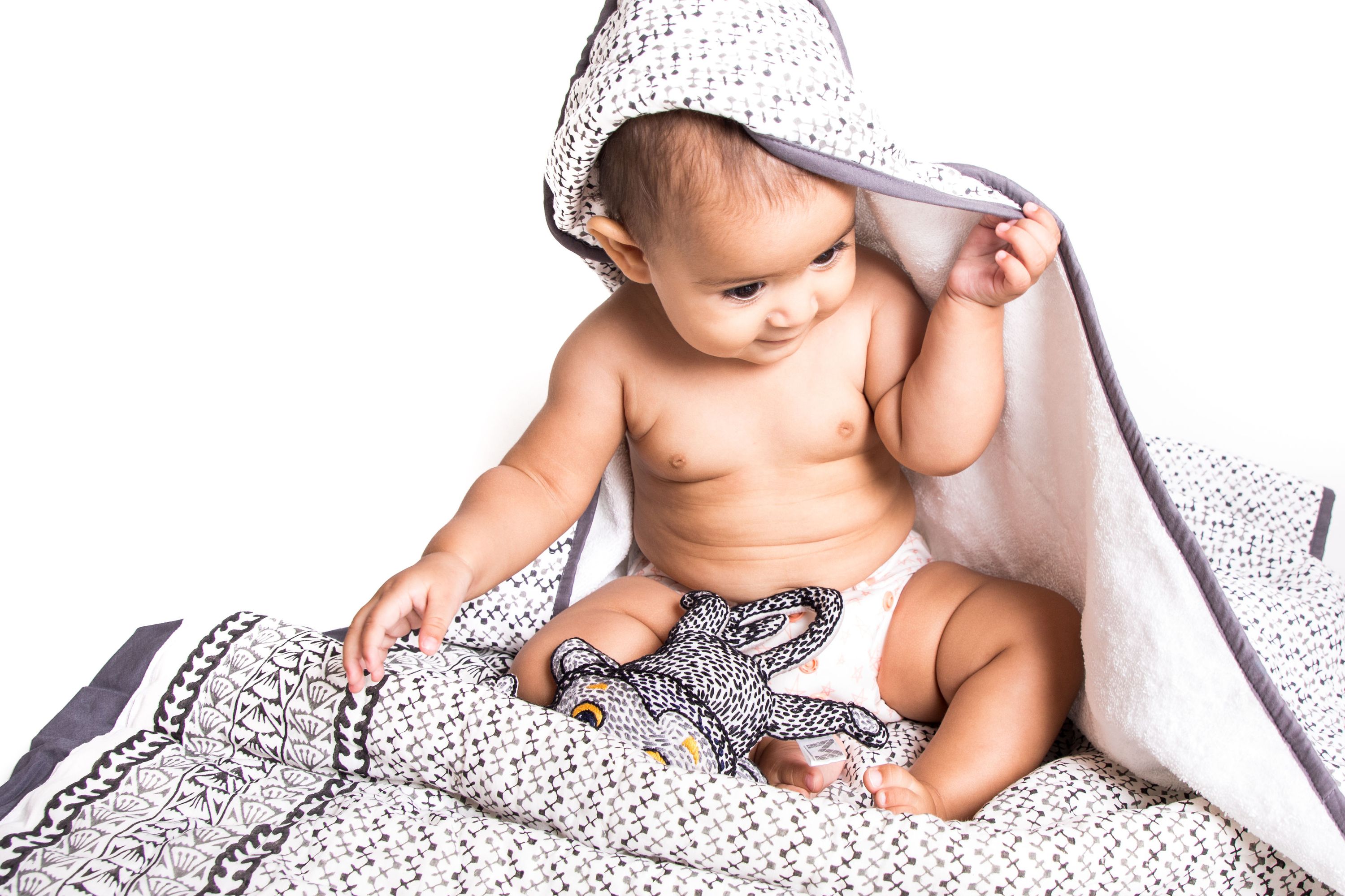 A beautifully designed GREENWICH TOWEL featuring soft cotton voile and plush terry, perfect for newborns to toddlers, with a unique handcrafted pattern.