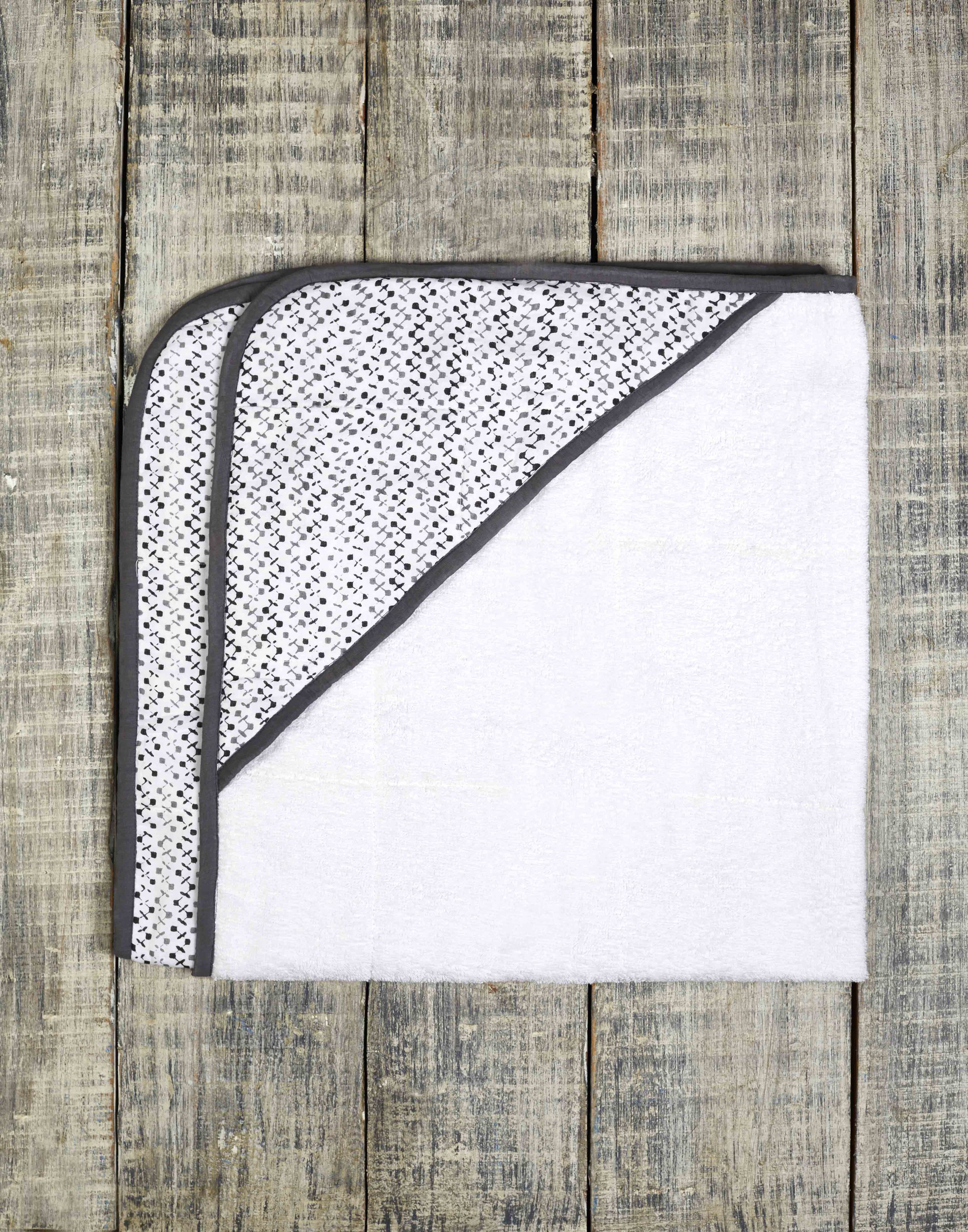 A beautifully designed GREENWICH TOWEL featuring soft cotton voile and plush terry, perfect for newborns to toddlers, with a unique handcrafted pattern.