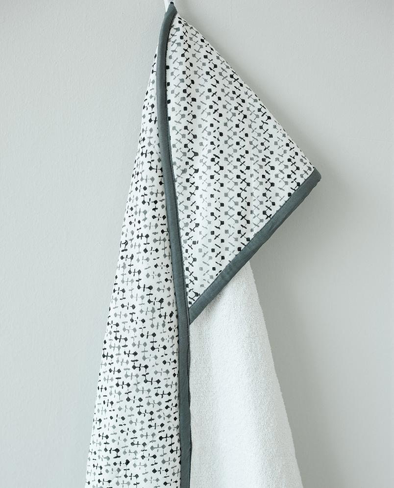 A beautifully designed GREENWICH TOWEL featuring soft cotton voile and plush terry, perfect for newborns to toddlers, with a unique handcrafted pattern.