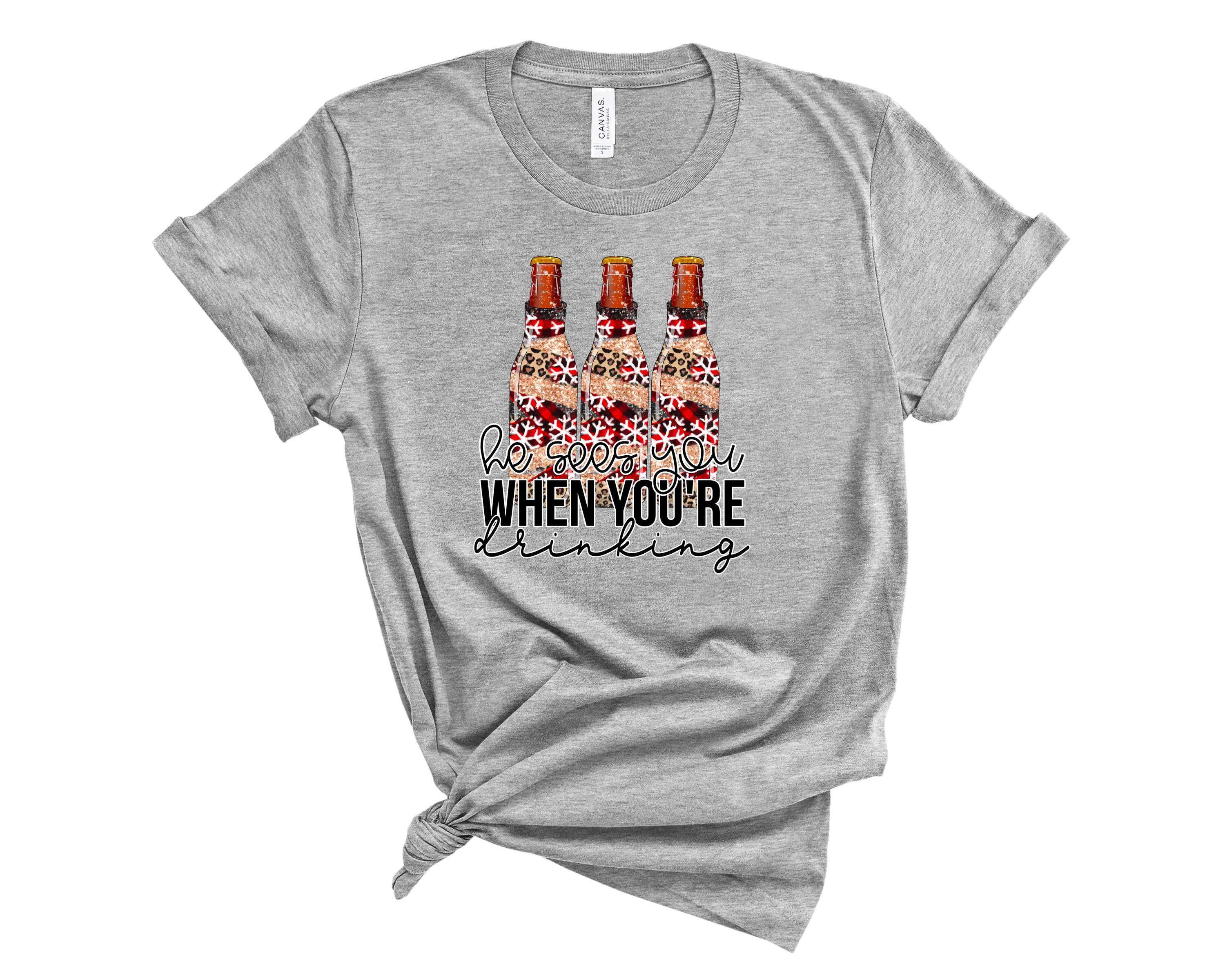 He Sees You When You're Drinking Graphic Tee featuring a humorous design on a soft unisex t-shirt.