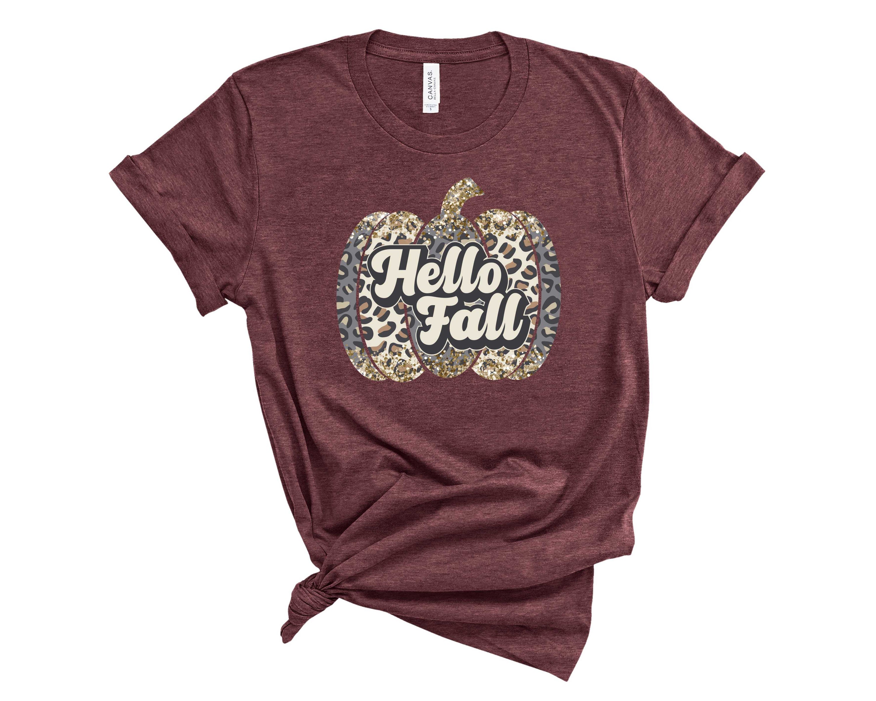Hello Fall Leopard Pumpkin Graphic Tee featuring a stylish leopard print pumpkin design on a soft unisex t-shirt.