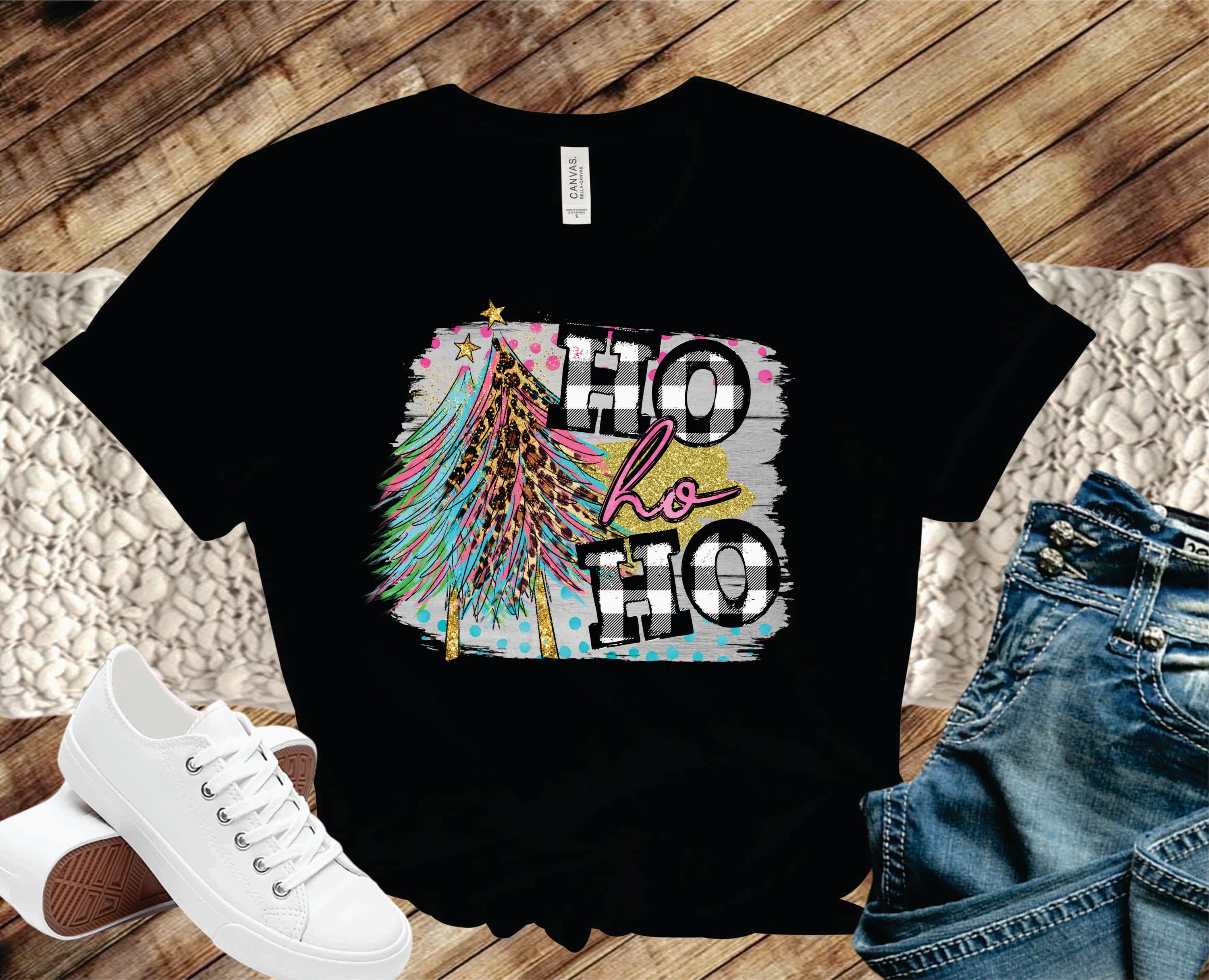 A festive unisex graphic tee featuring 'Ho Ho Ho' text and Christmas trees, perfect for holiday celebrations.
