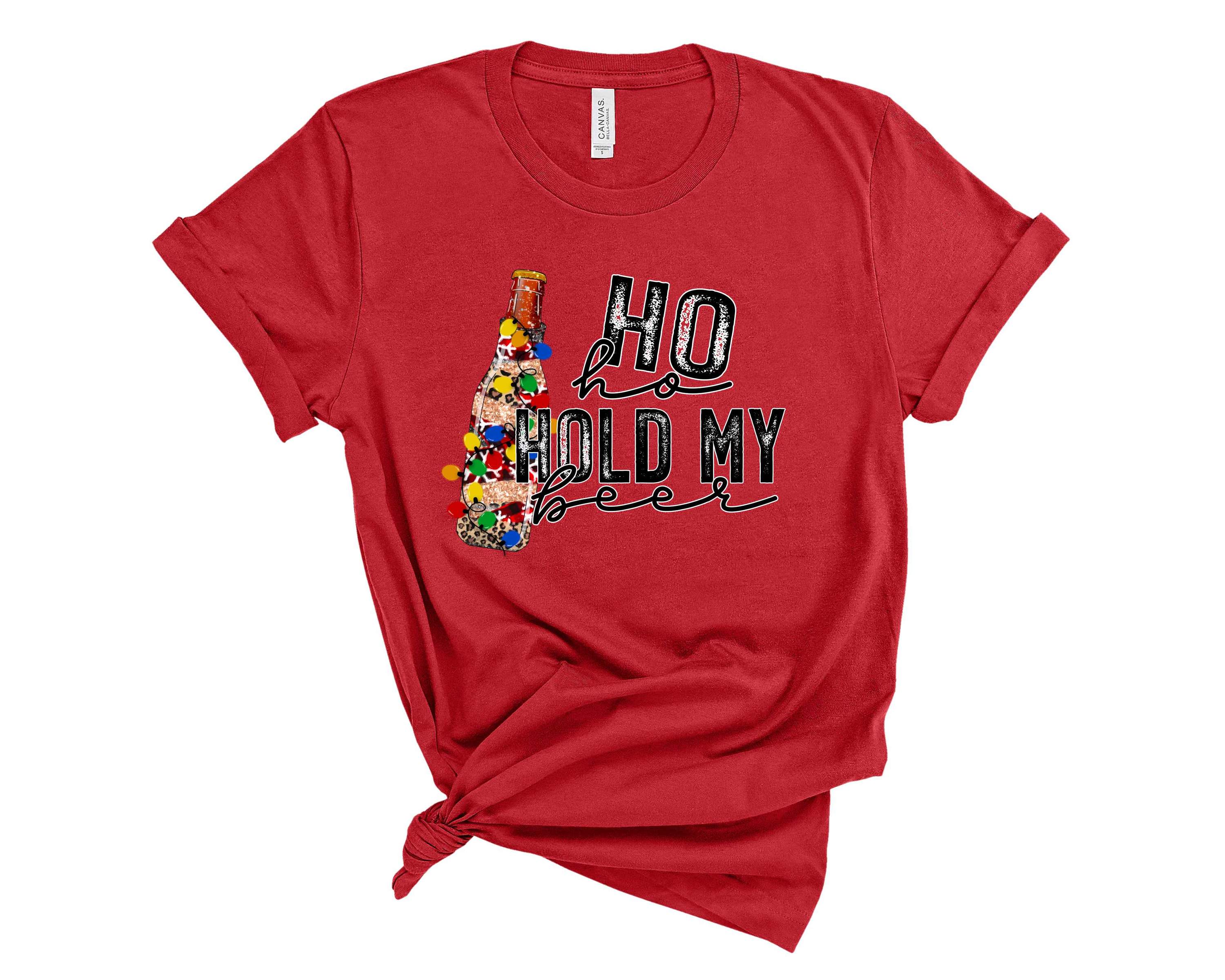 A unisex graphic tee featuring the phrase 'Ho Ho Hold My Beer' in a festive design, perfect for holiday gatherings.