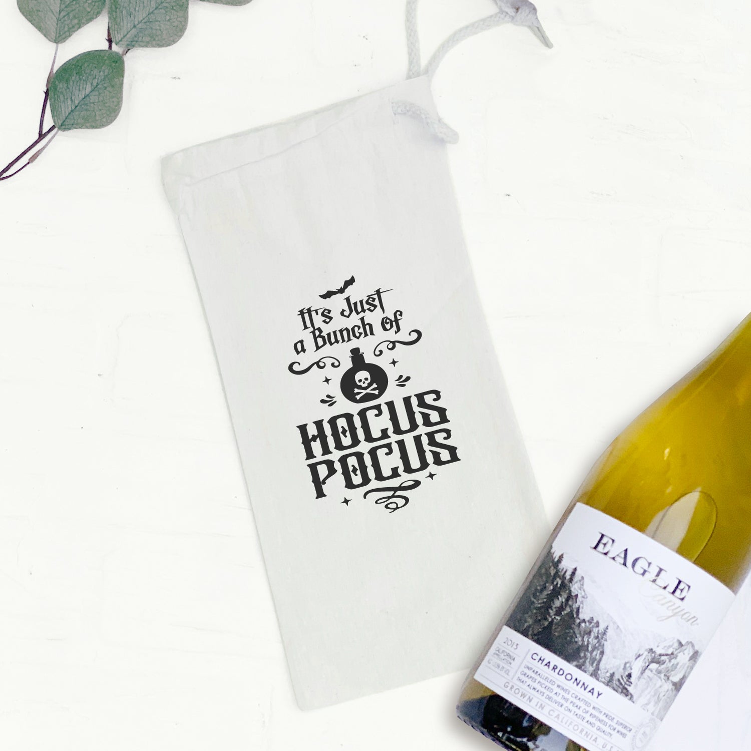 Hocus Pocus canvas wine bag featuring a drawstring closure, designed to hold a standard 750mL wine bottle, perfect for gifting.