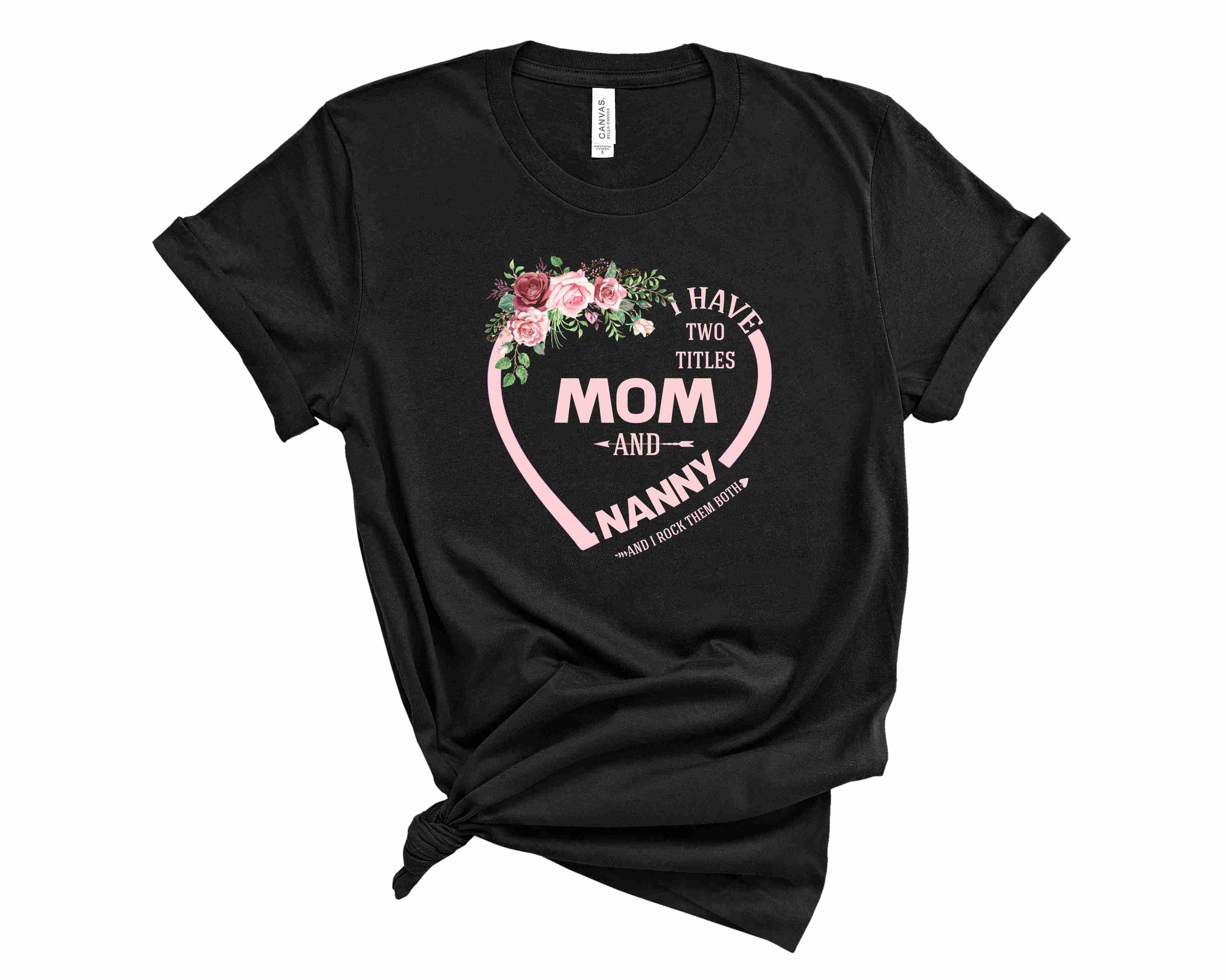 A unisex graphic tee featuring the phrase 'I Have Two Titles Mom & Nanny' in bold letters, showcasing a stylish and comfortable design.