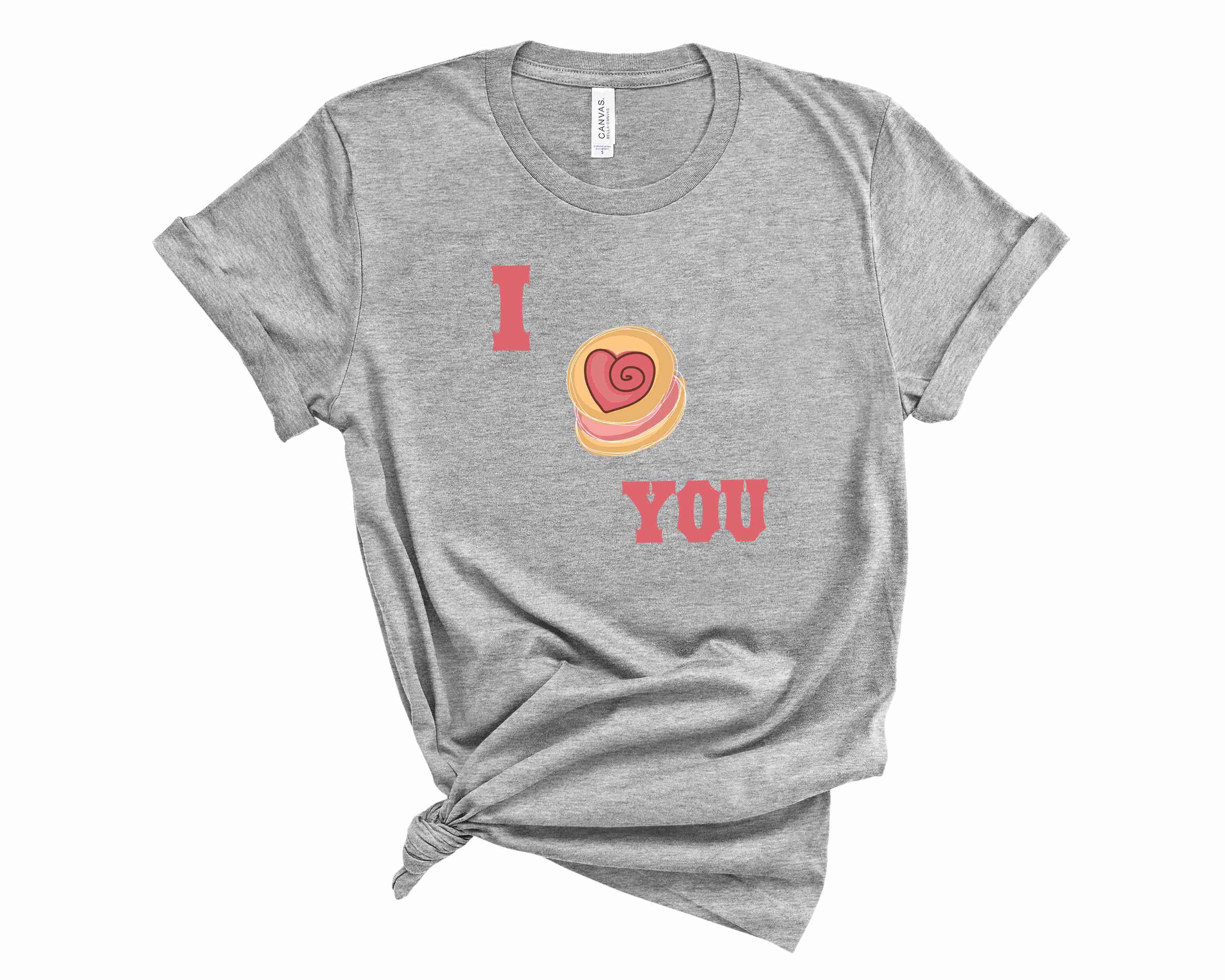 I Heart You Macaron Graphic Tee featuring a colorful macaron design on a soft unisex t-shirt.
