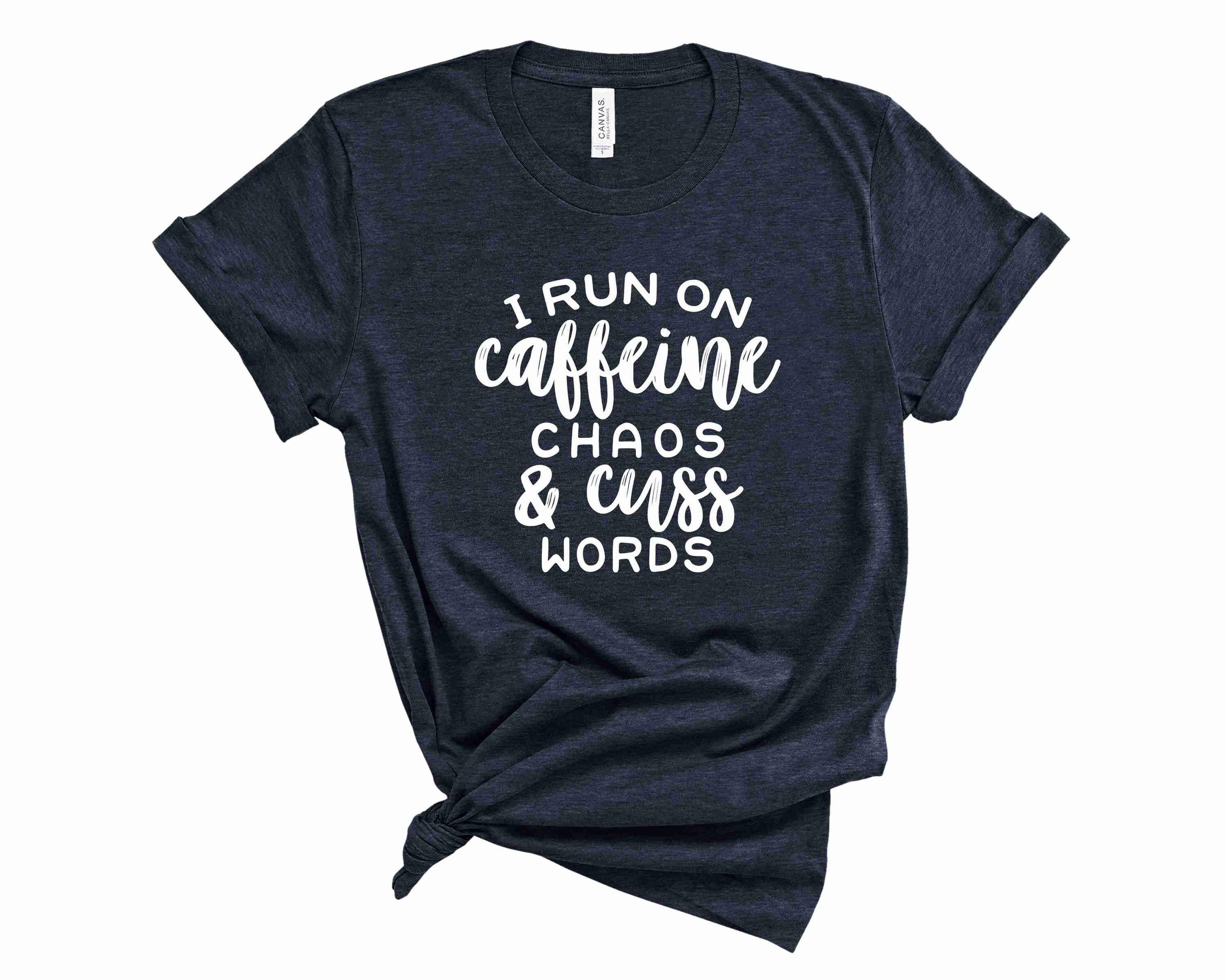 A unisex graphic tee featuring the phrase 'I Run on Caffeine Chaos and Cuss Words' in bold lettering, perfect for casual wear.