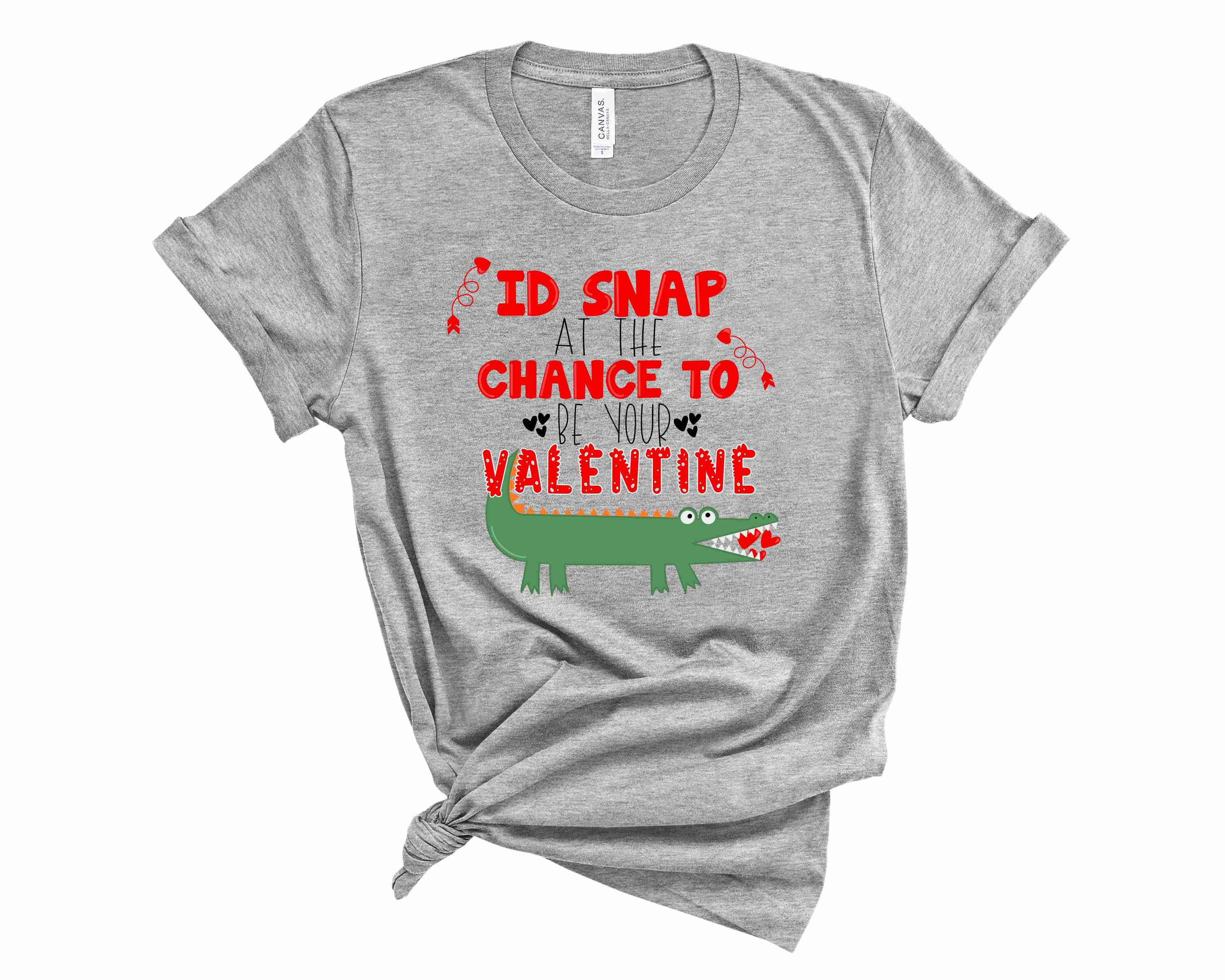 Unisex graphic tee featuring 'I'd Snap to be Your Valentine' text in vibrant colors.