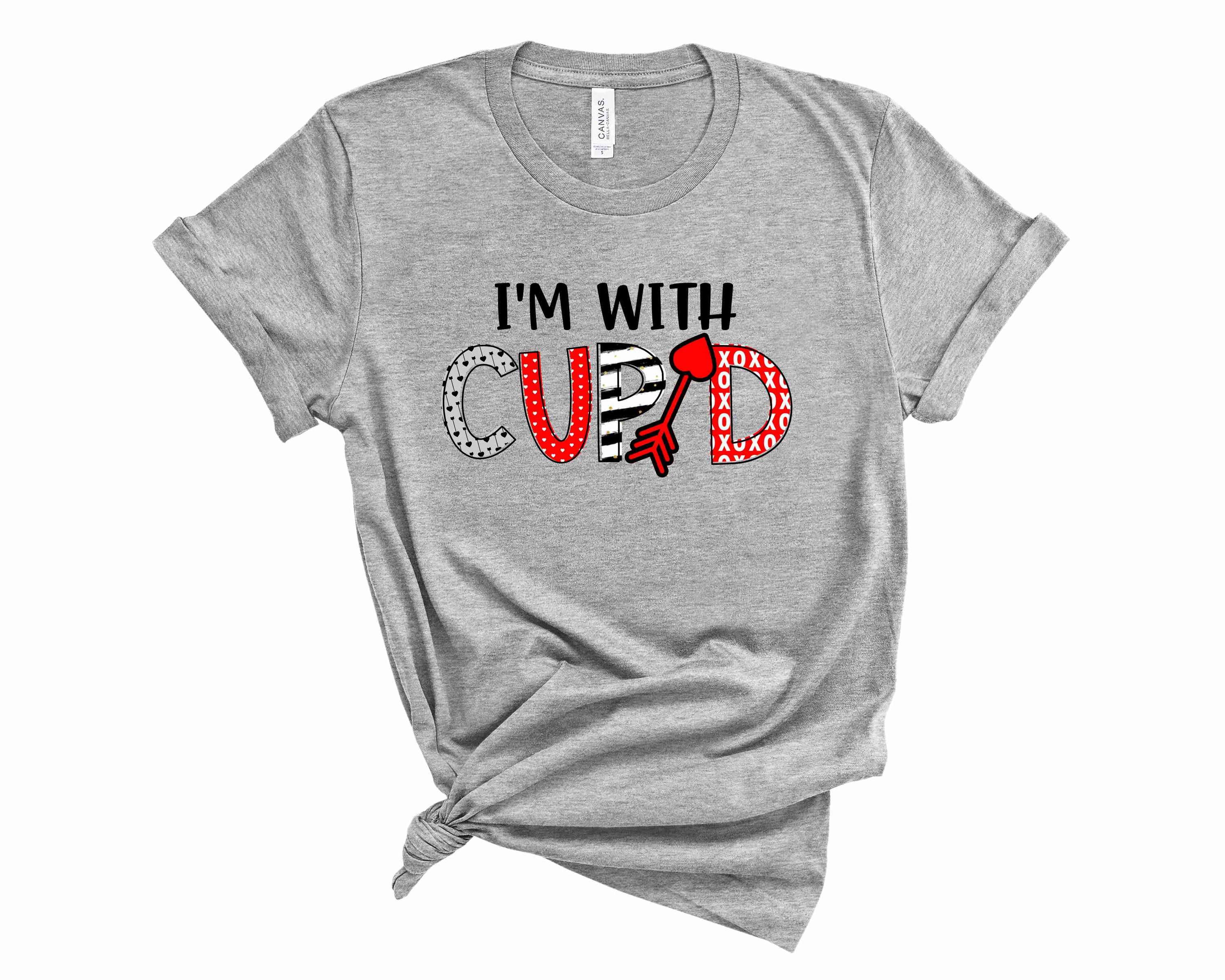 I'm With Cupid Graphic Tee featuring a playful Cupid design on a soft unisex t-shirt.