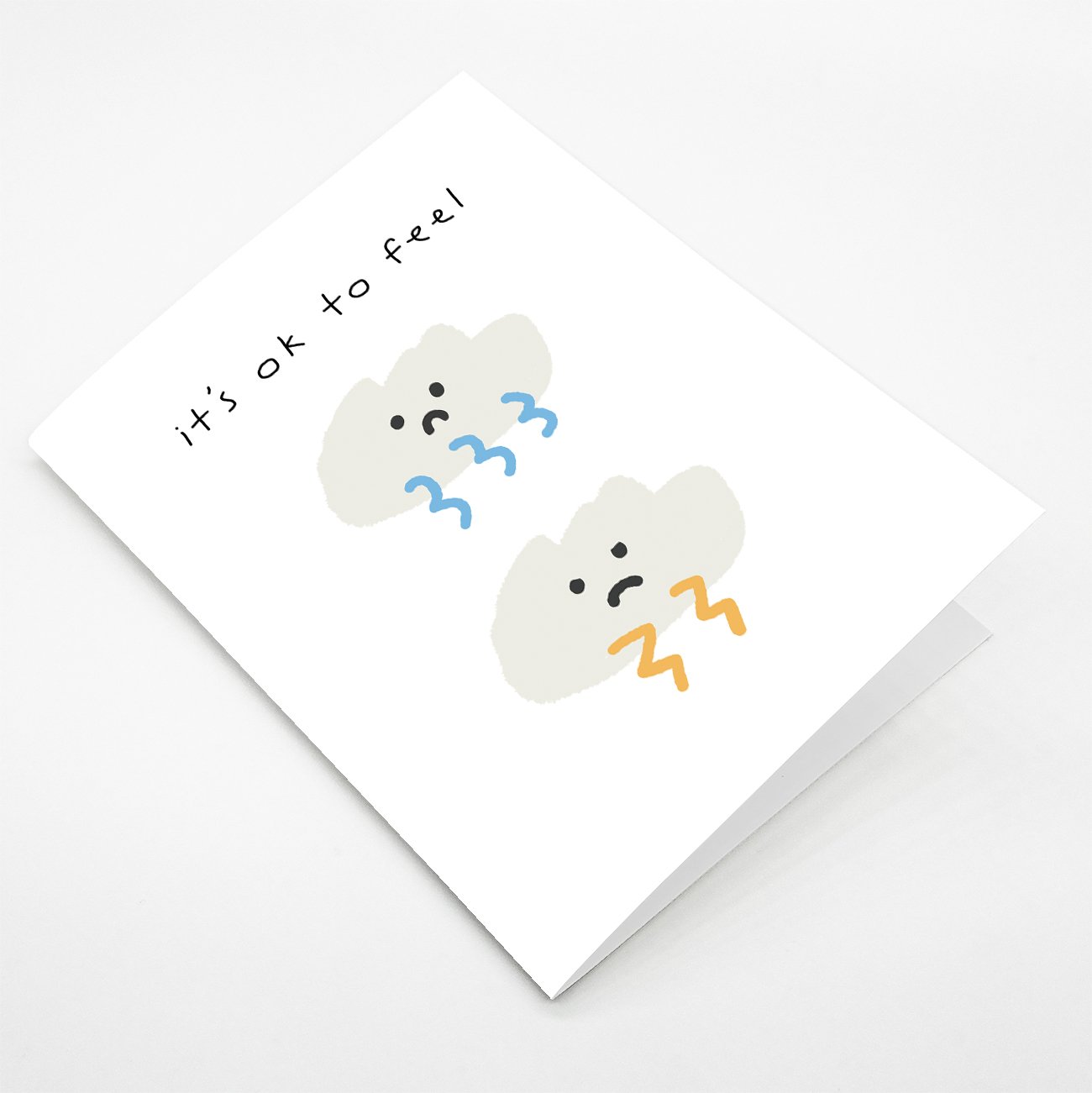 Uplifting illustrated sympathy card titled 'It's Ok to Feel' with a Kraft envelope, showcasing a comforting design.
