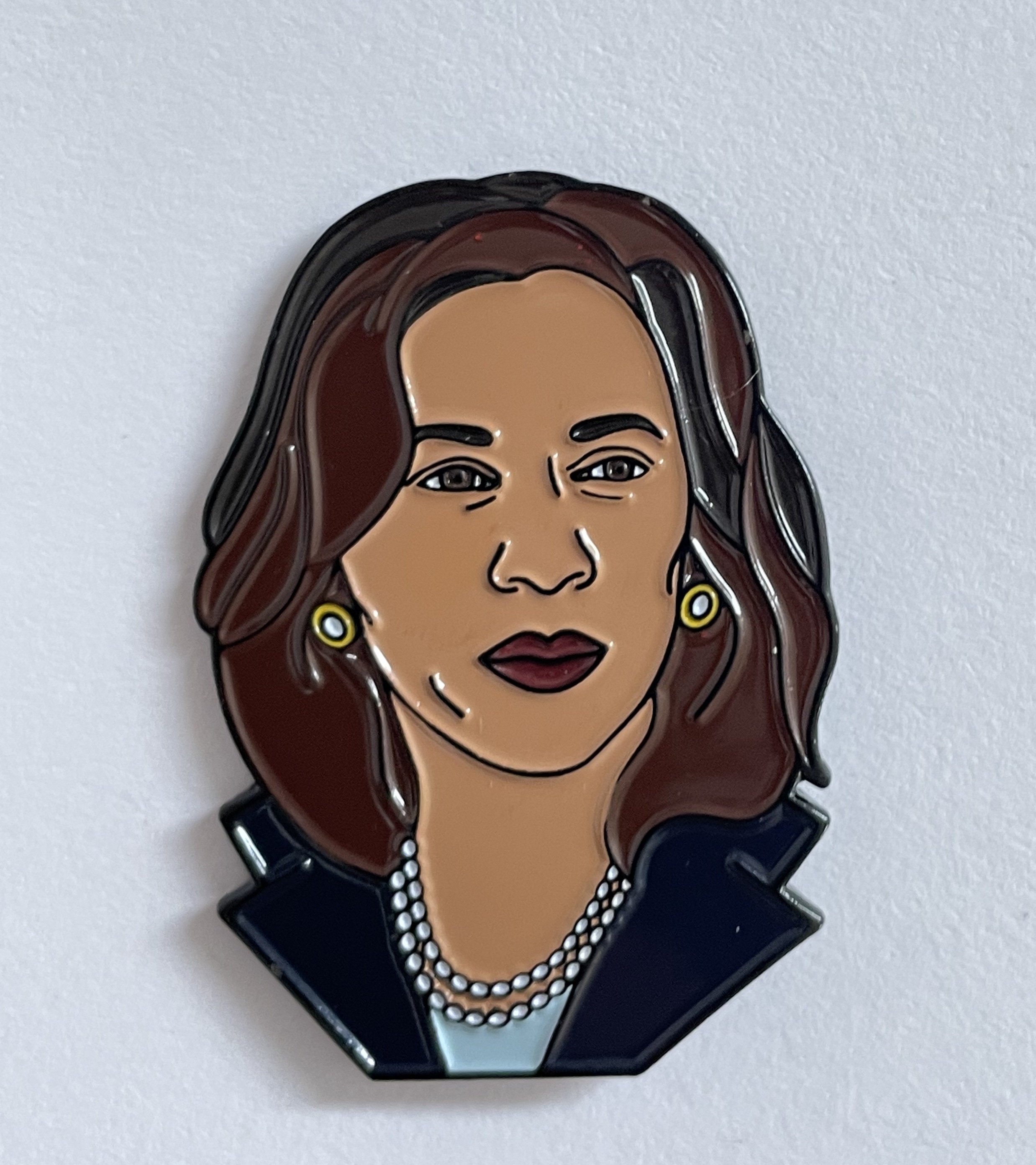 Kamala Harris enamel pin featuring vibrant colors and detailed design, perfect for bags or shirts.